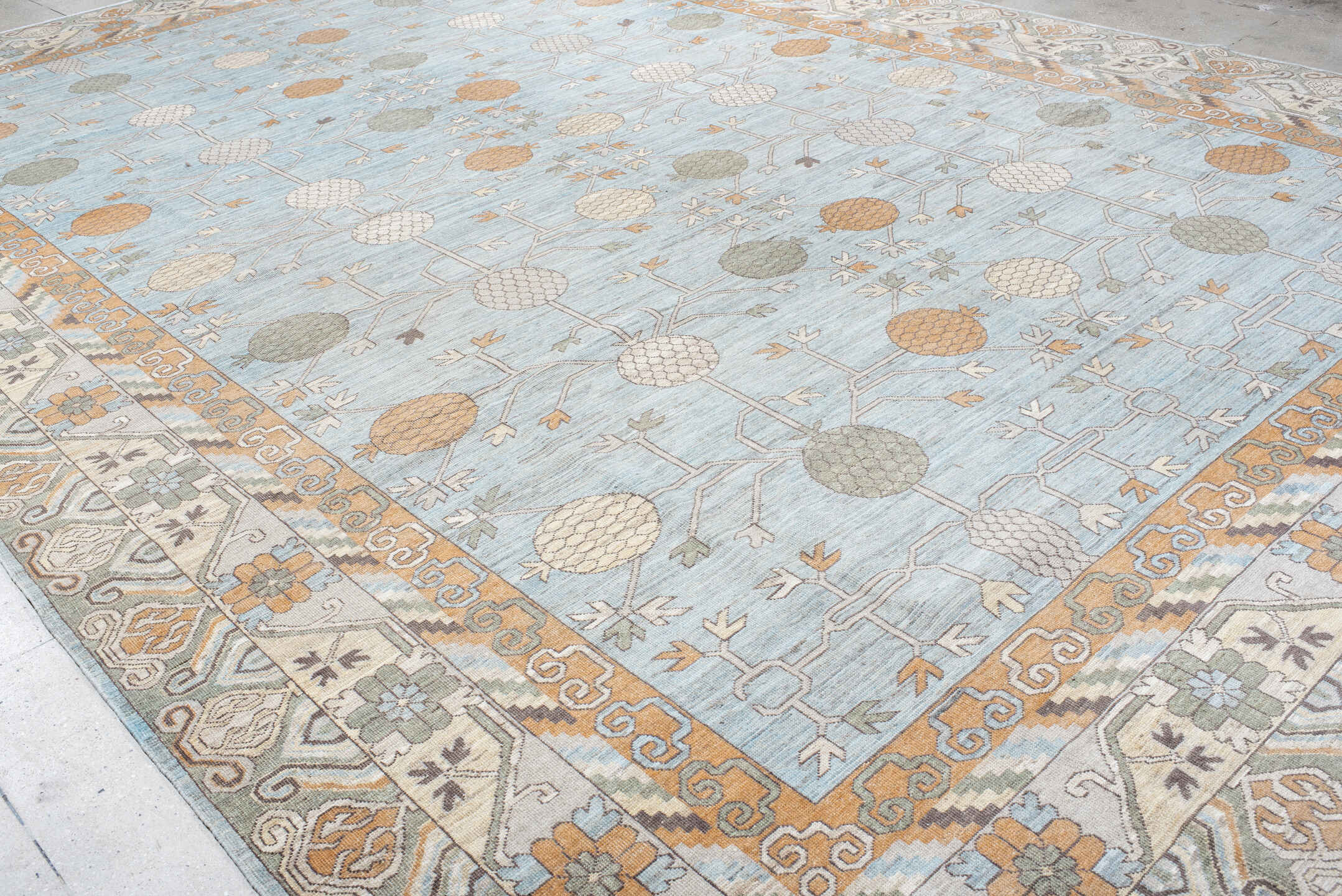 13' x 19' one-of-a-kind handmade vintage Khotan oversize rug. Color palette: pale blue, ivory, peach, taupe, sage, camel