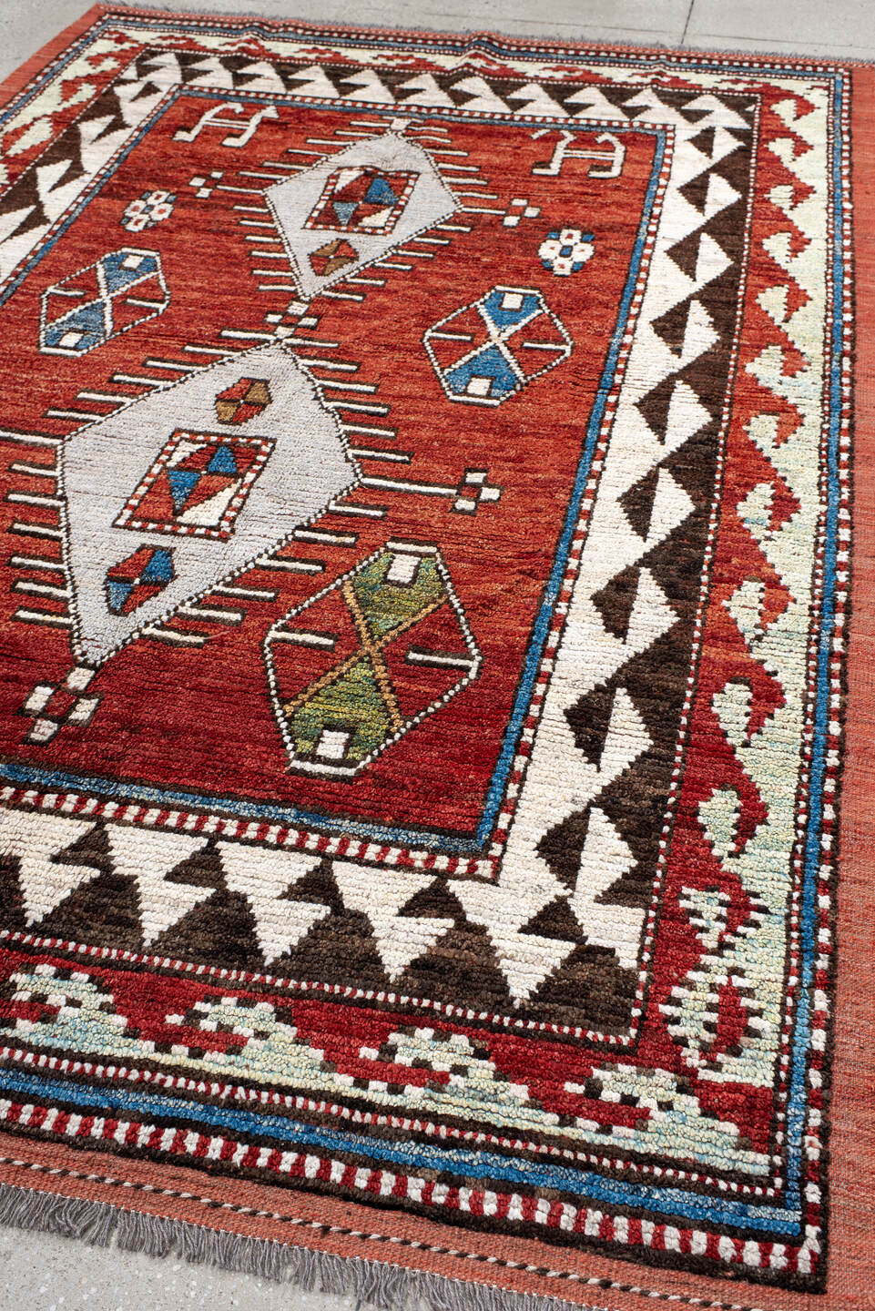 6' x 10' one-of-a-kind handmade vintage Tulu large size rug. Color palette: rust, ivory, brown, brick, blue, olive, charcoal