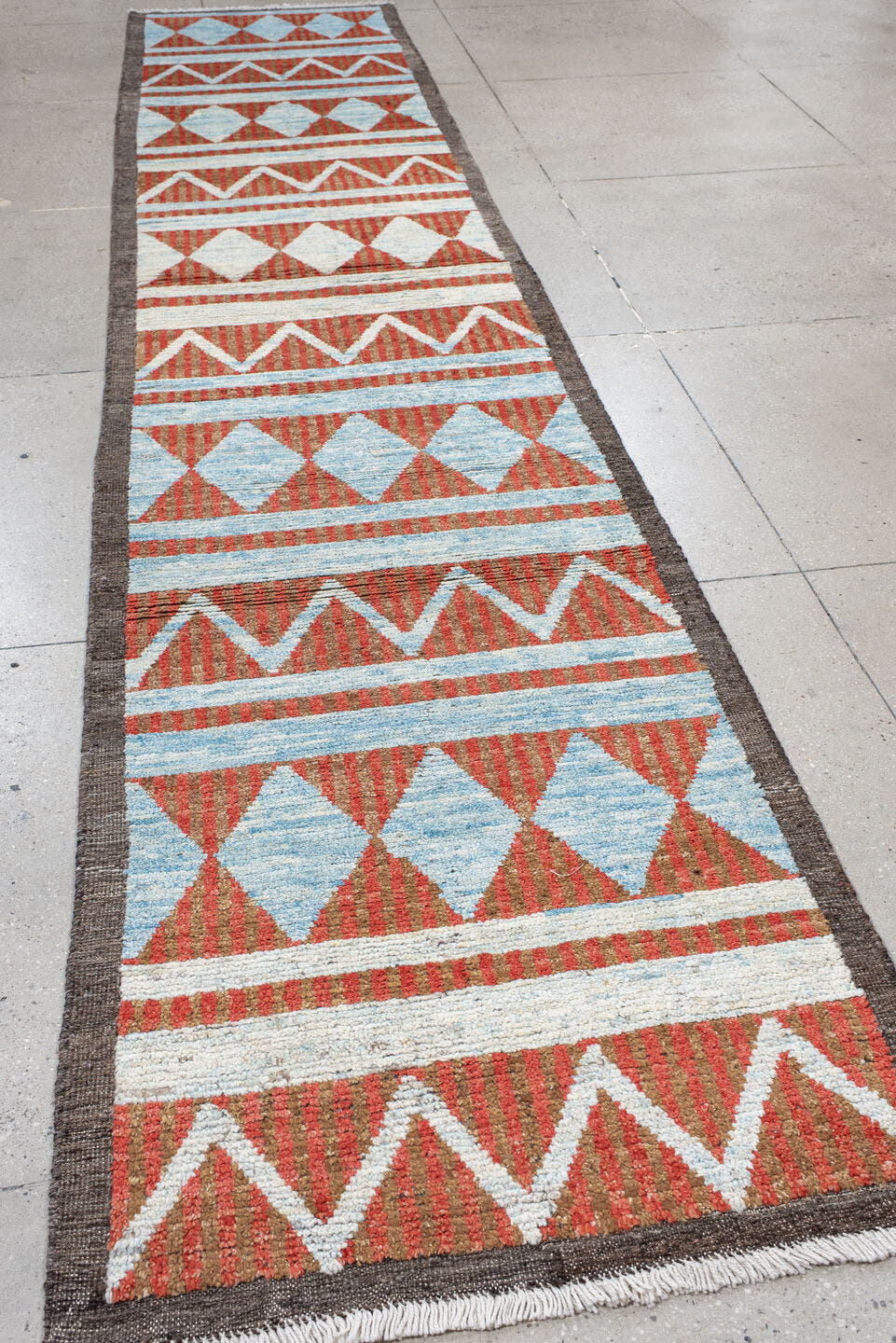 3' x 16' one-of-a-kind handmade vintage Tulu runner rug. Color palette: rust, ivory, sky blue, charcoal, terracotta, brown