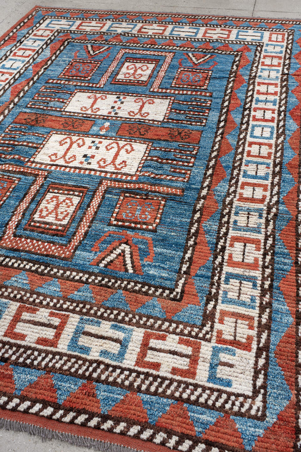 7' x 9' one-of-a-kind handmade vintage Tulu large size rug. Color palette: sky blue, rust, ivory, dark brown, brick, black