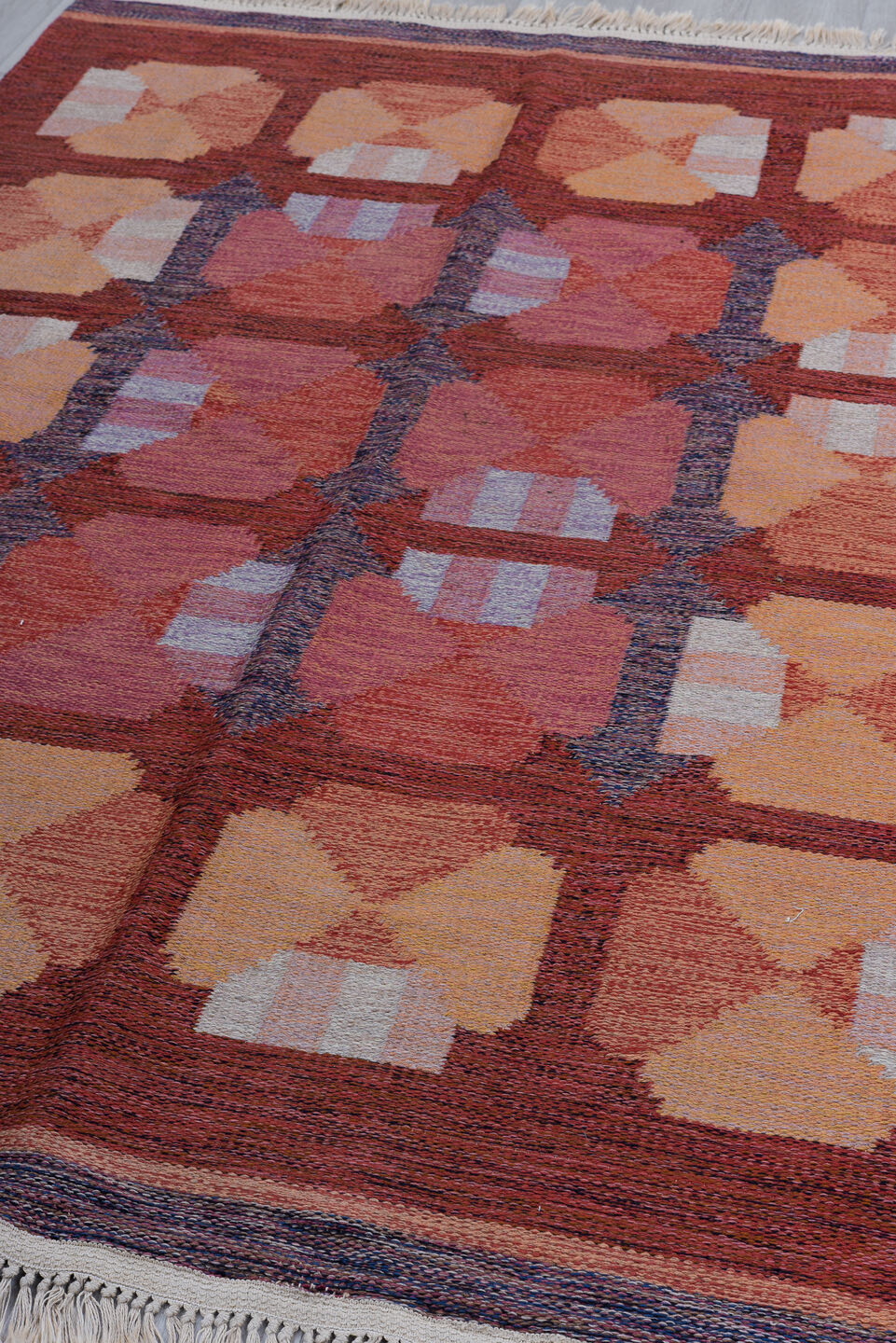 5' x 8' one-of-a-kind handmade vintage Rollaken medium size rug. Color palette: black, blue, brown, gray, indian red