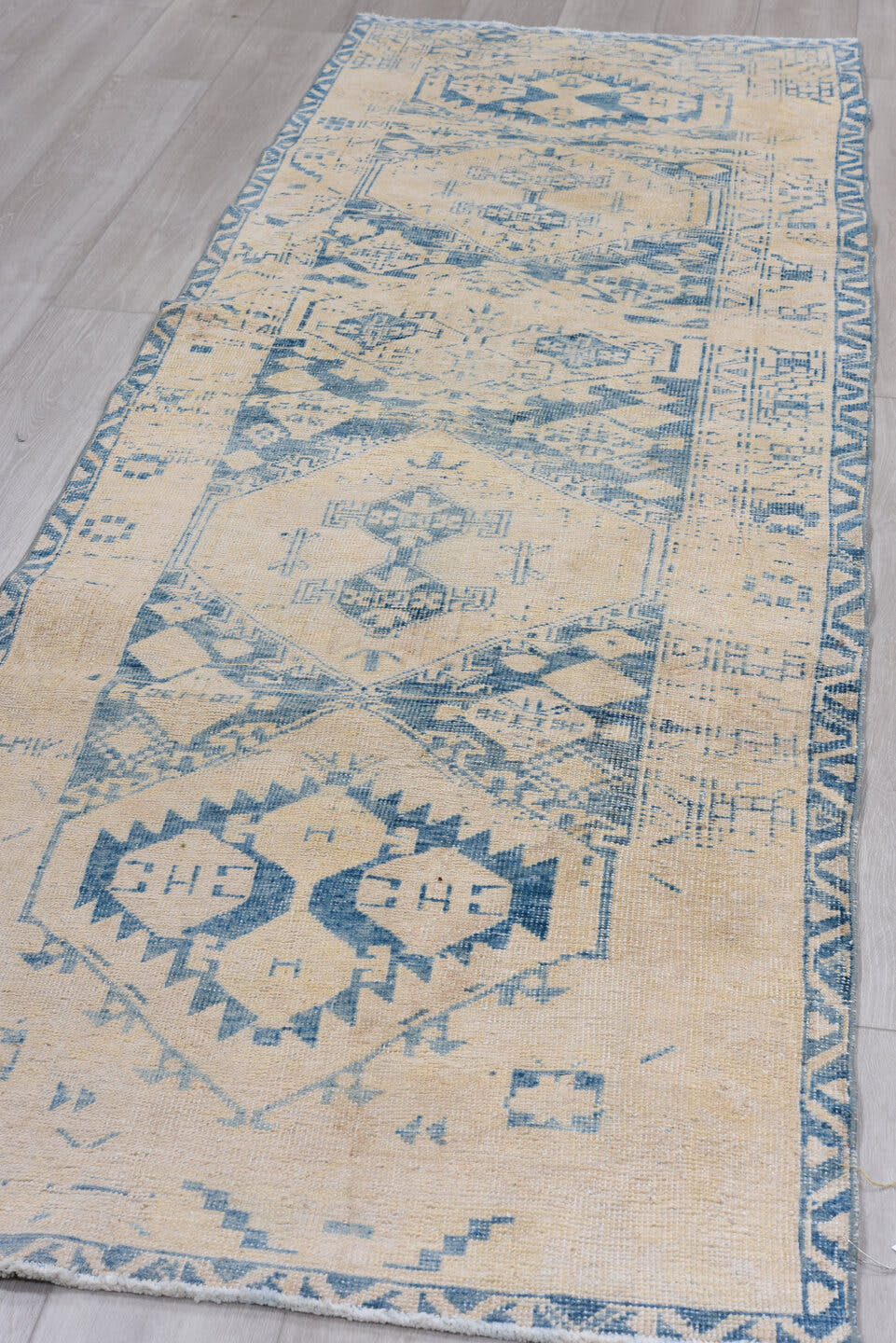 3' x 9' one-of-a-kind handmade antique Heriz runner rug. Color palette: ivory, sky blue, beige, camel, light blue