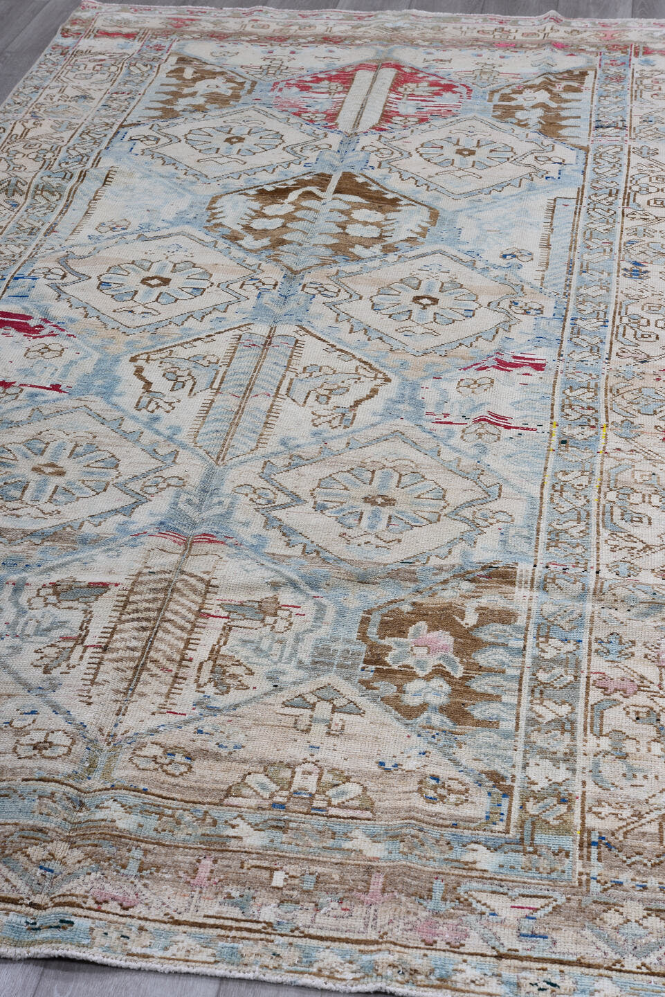 5' x 9' one-of-a-kind handmade antique Baktiary medium size rug. Color palette: ivory, sky blue, camel, brown, rose, crimson