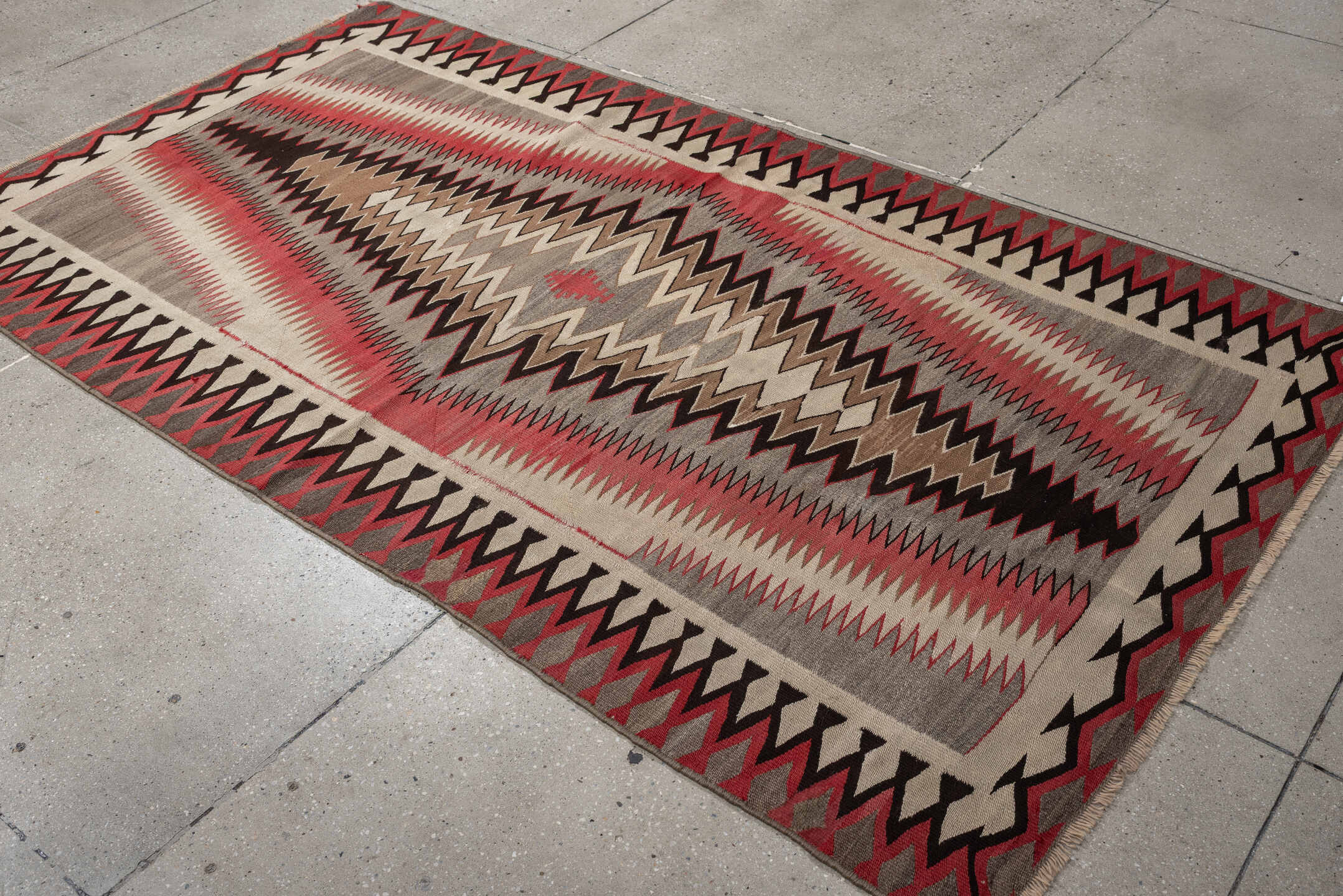 4' x 7' one-of-a-kind handmade vintage Navajo rug. Color palette: ivory, rust, taupe, charcoal, black, camel, terracotta