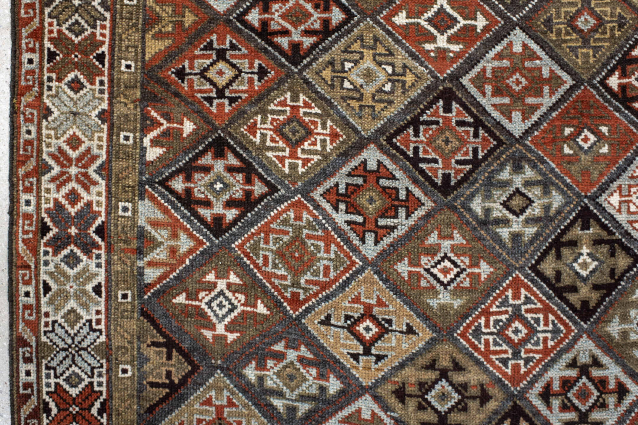 3' x 9' one-of-a-kind handmade antique Kurd runner rug. Color palette: taupe, rust, ivory, brown, charcoal, camel, burgundy