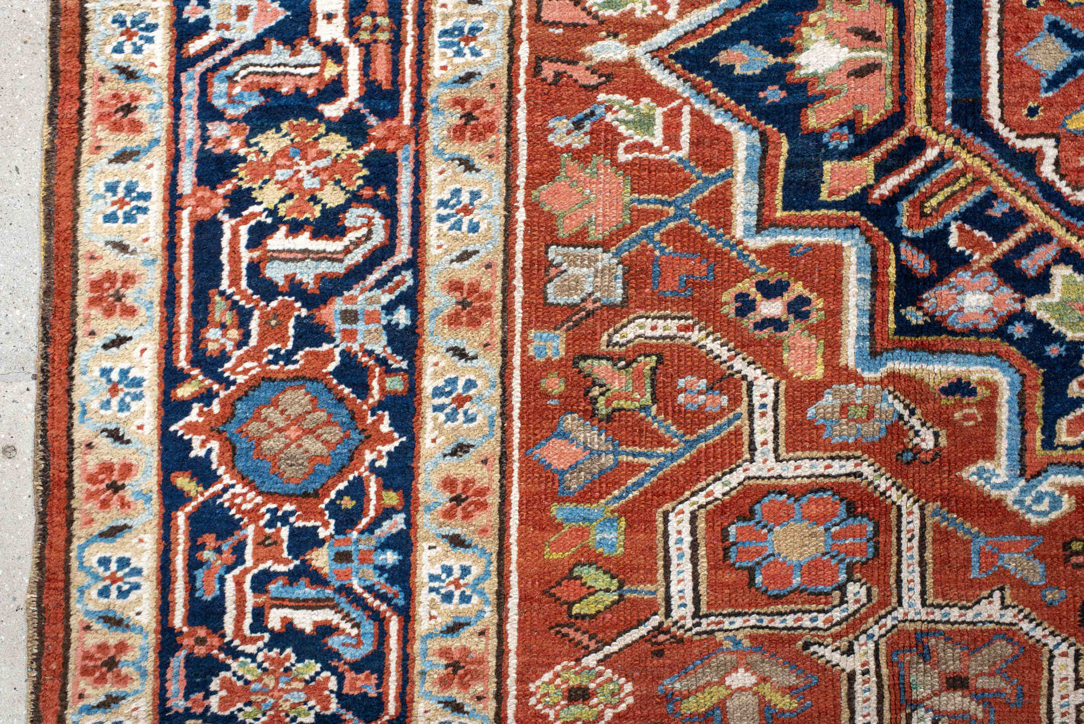 7' x 11' one-of-a-kind handmade antique Heriz large size rug. Color palette: rust, navy, ivory, sky blue, terra cotta, camel