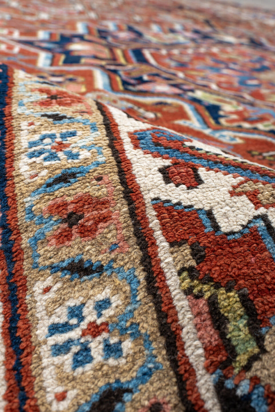 7' x 11' one-of-a-kind handmade antique Heriz large size rug. Color palette: rust, navy, ivory, sky blue, terra cotta, camel