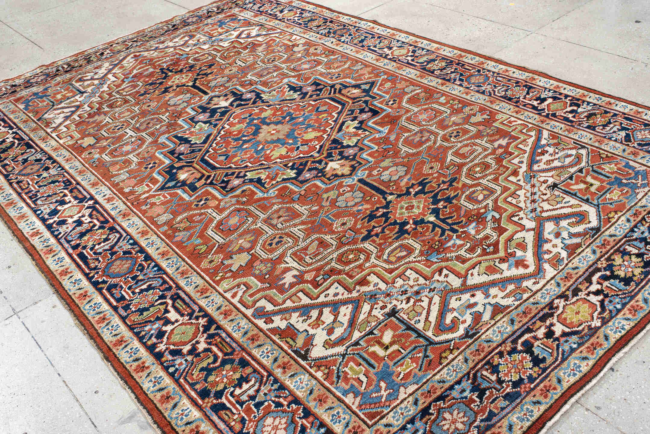 7' x 11' one-of-a-kind handmade antique Heriz large size rug. Color palette: rust, navy, ivory, sky blue, terra cotta, camel