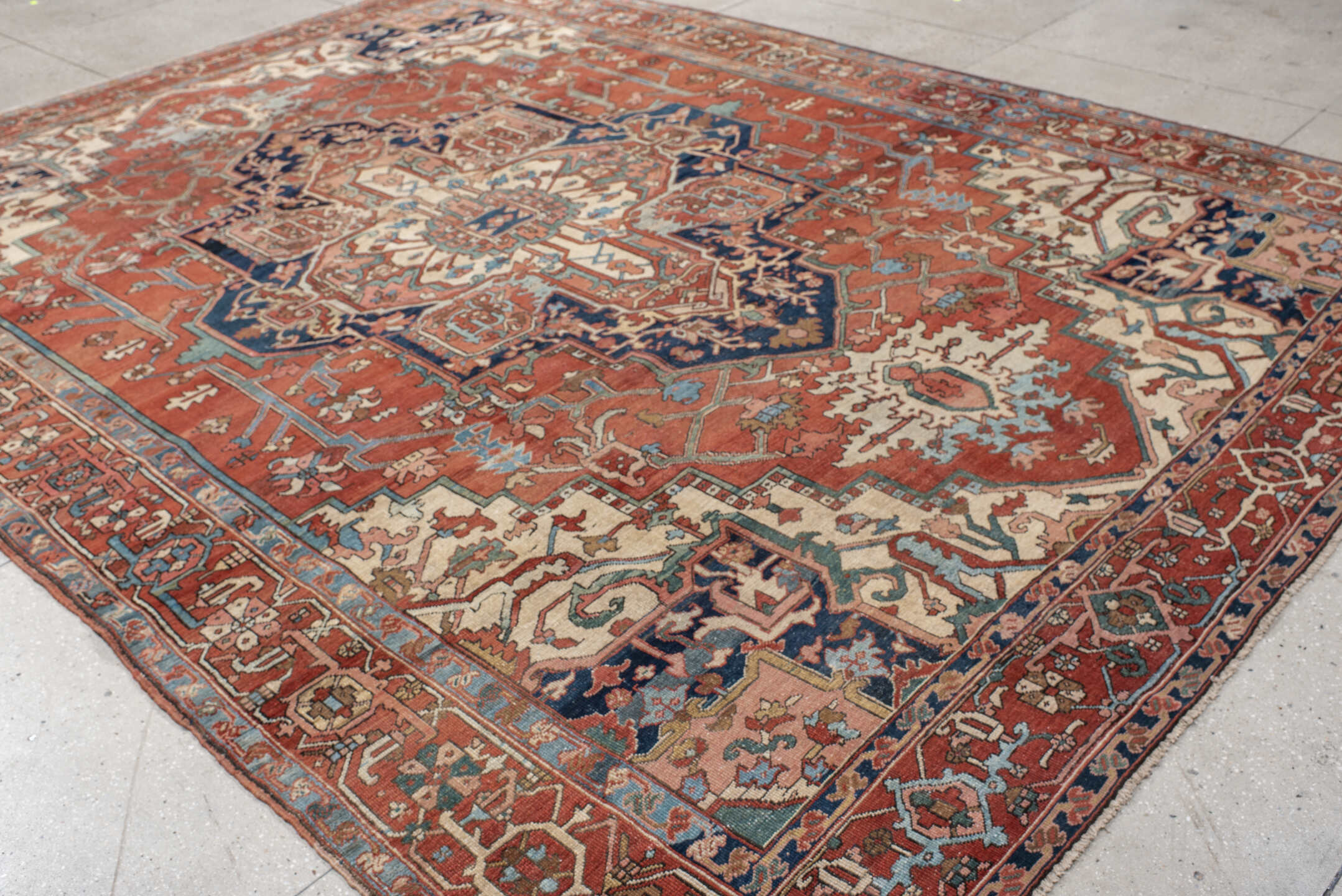 9' x 12' one-of-a-kind handmade vintage Serapi large size rug. Color palette: terra cotta, ivory, sky blue, navy, rust