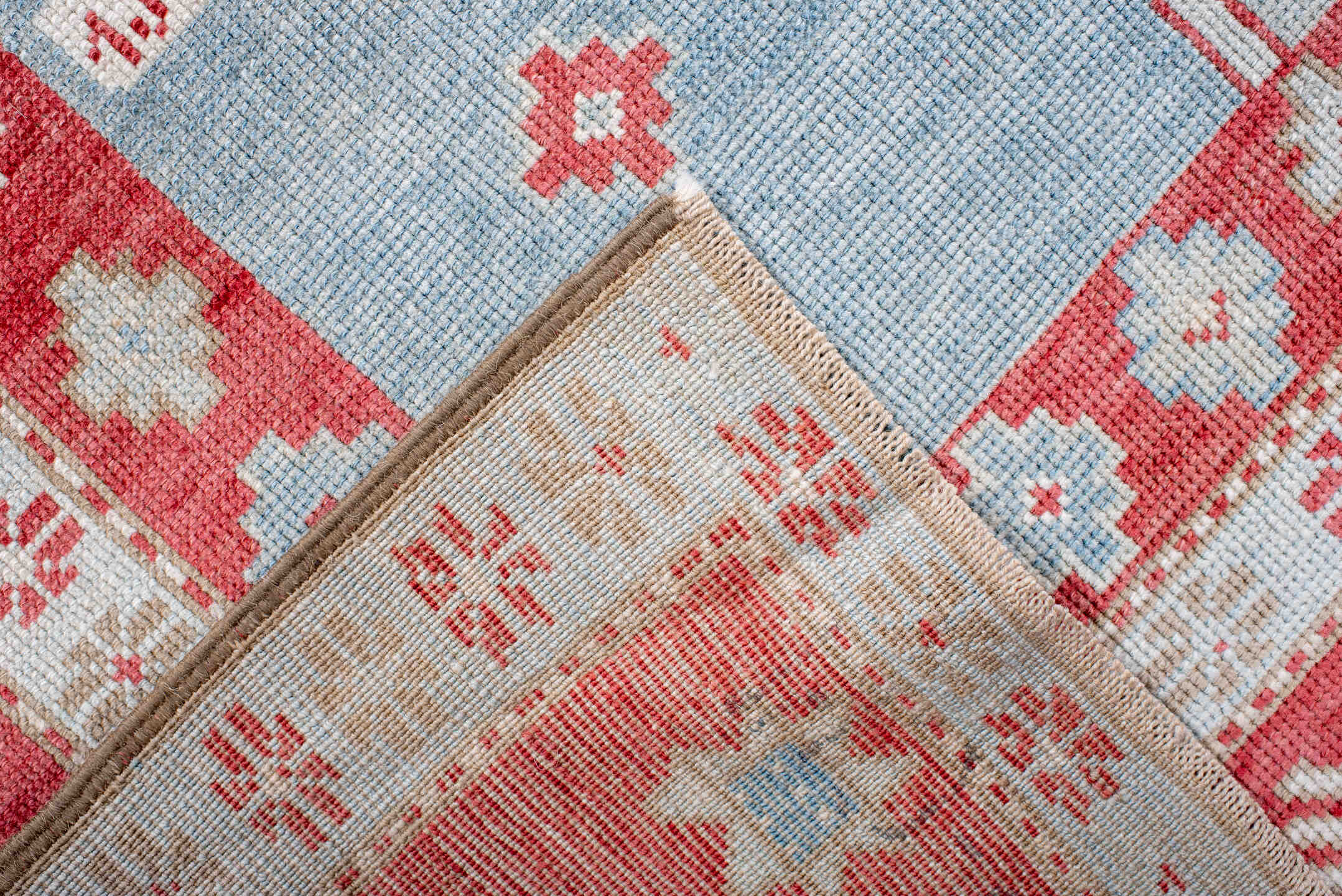5' x 7' one-of-a-kind handmade antique Caucasian rug. Color palette: sky blue, coral, ivory, brick red, pale blue