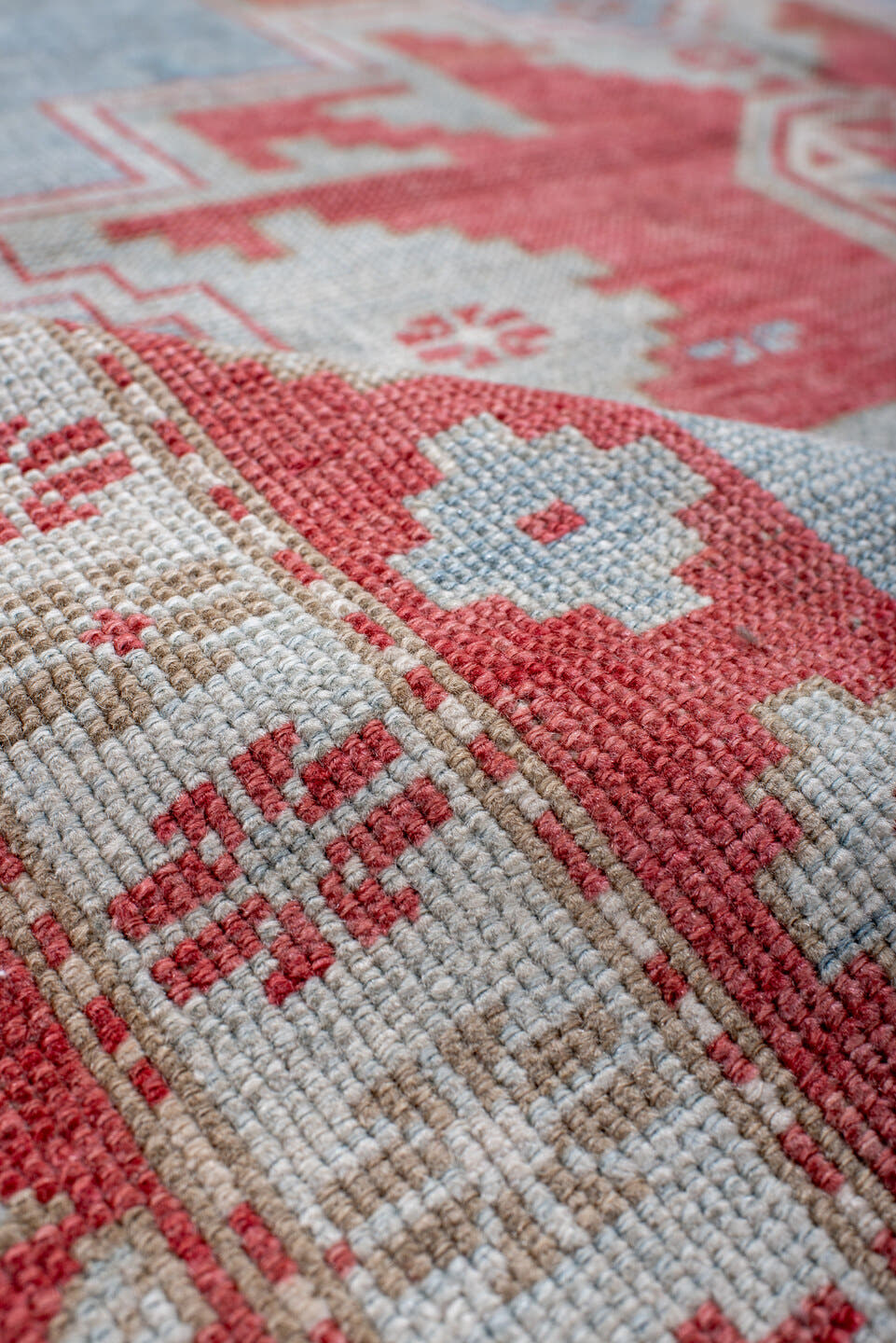 5' x 7' one-of-a-kind handmade antique Caucasian rug. Color palette: sky blue, coral, ivory, brick red, pale blue