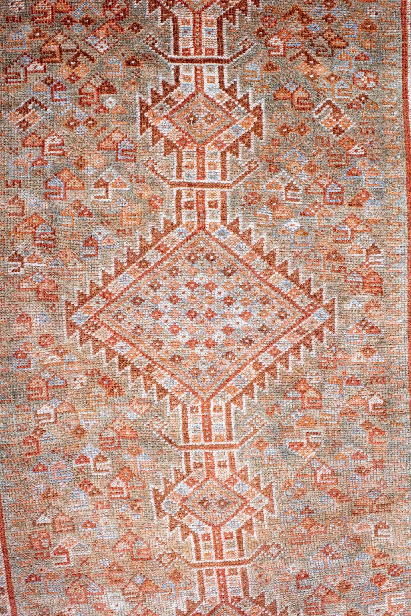 4' x 8' one-of-a-kind handmade antique Shiraz rug. Color palette: rust, ivory, pale blue, terra cotta, camel, taupe, brown