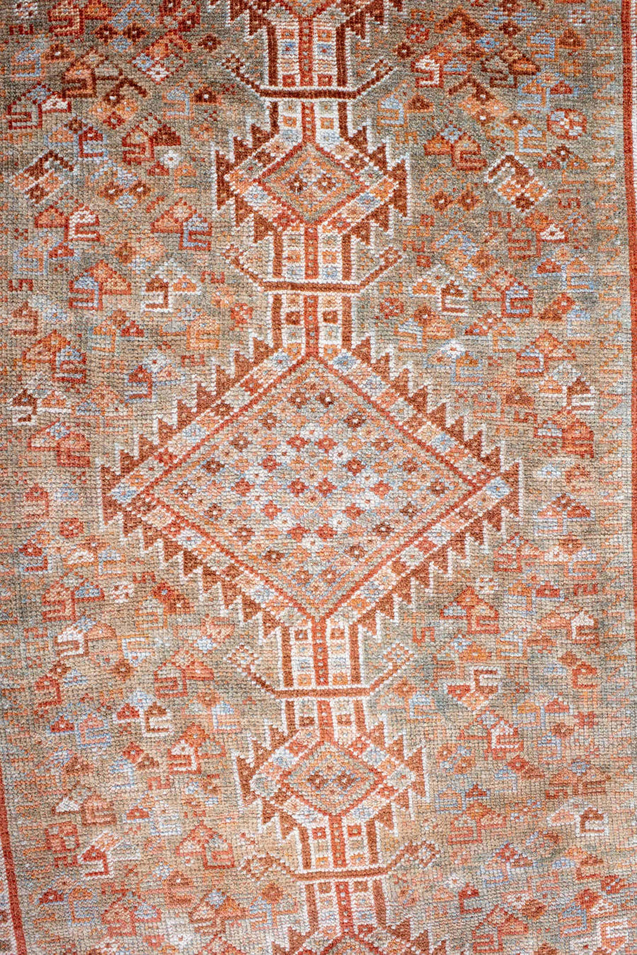 4' x 8' one-of-a-kind handmade antique Shiraz rug. Color palette: rust, ivory, pale blue, terra cotta, camel, taupe, brown