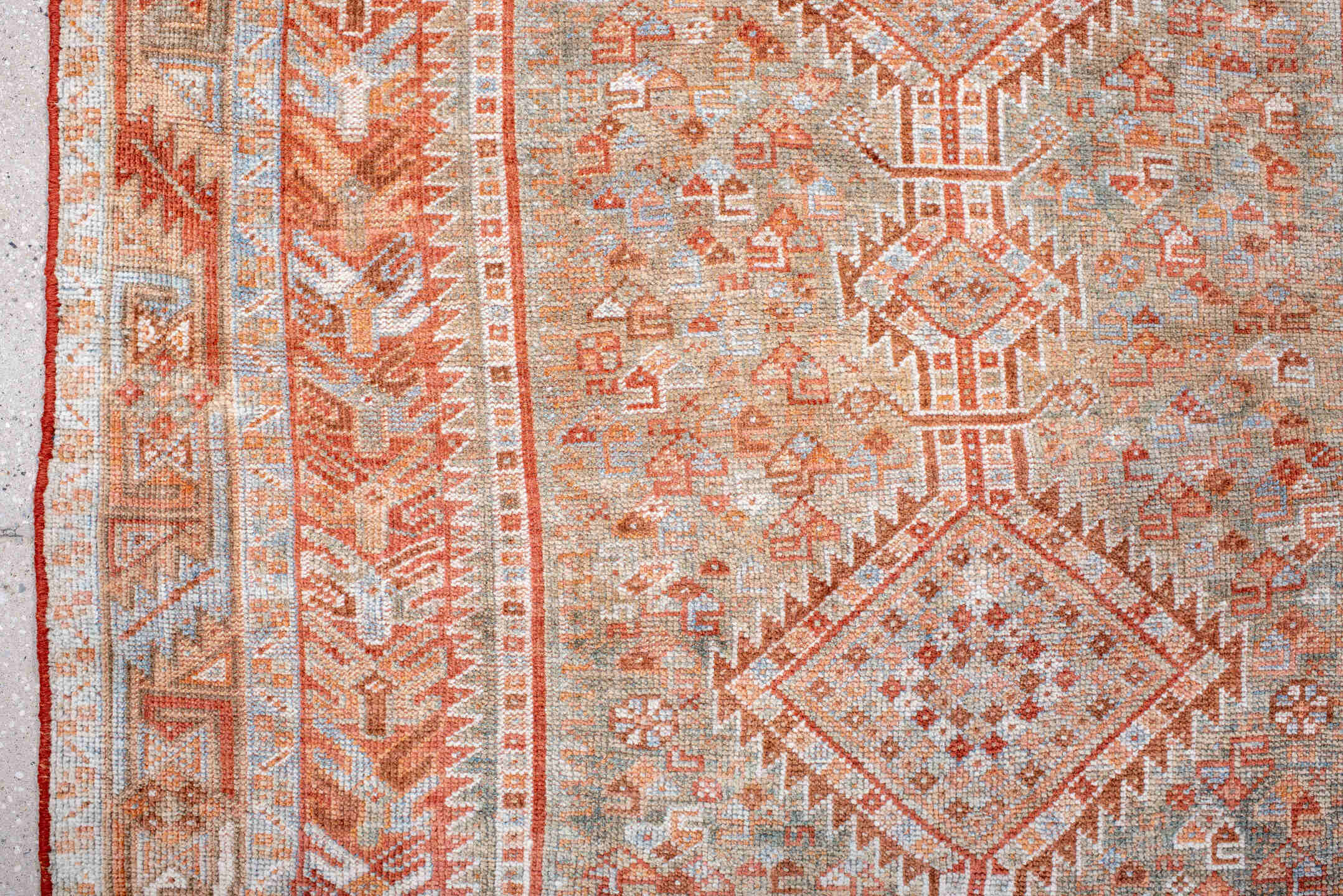 4' x 8' one-of-a-kind handmade antique Shiraz rug. Color palette: rust, ivory, pale blue, terra cotta, camel, taupe, brown