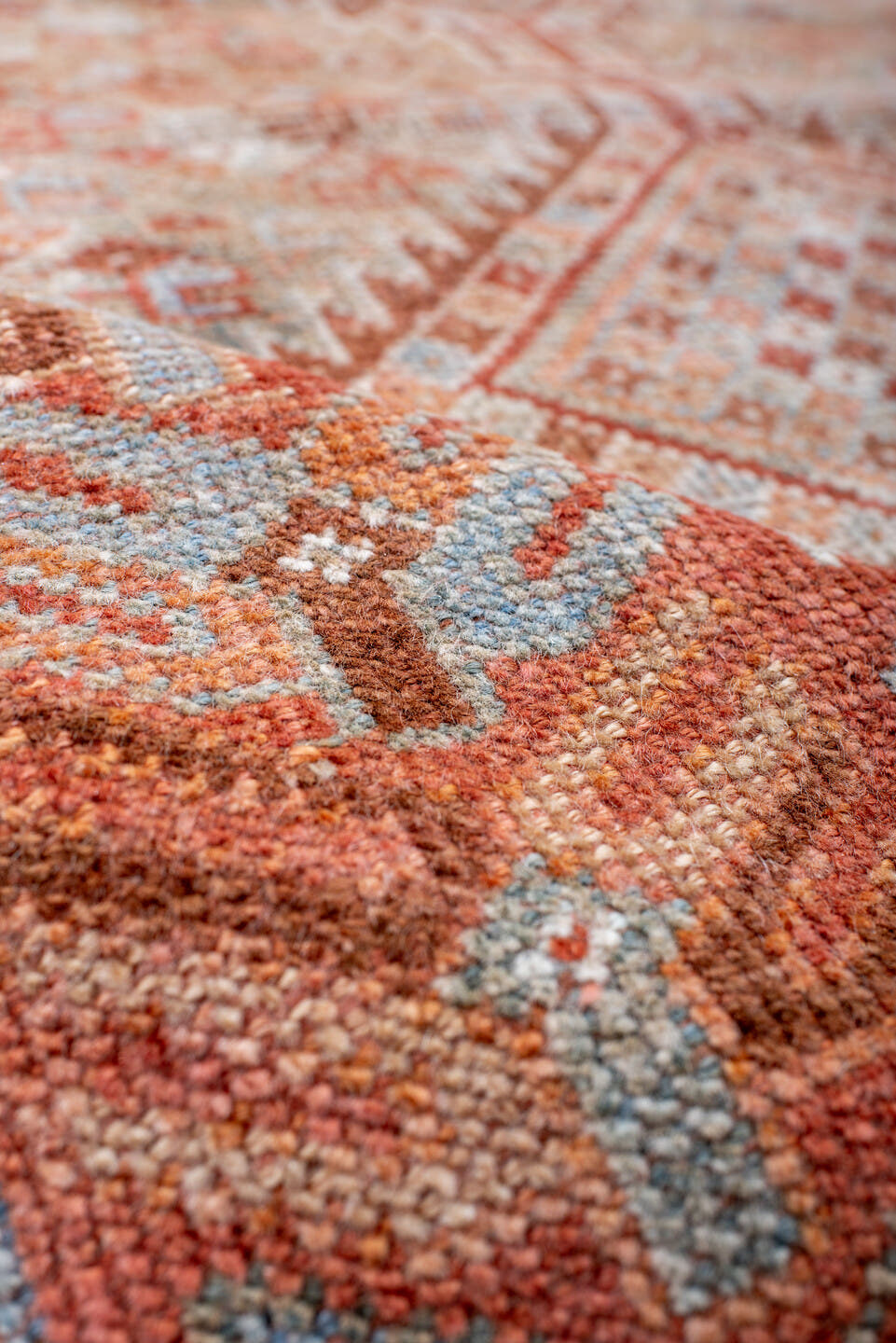 4' x 8' one-of-a-kind handmade antique Shiraz rug. Color palette: rust, ivory, pale blue, terra cotta, camel, taupe, brown