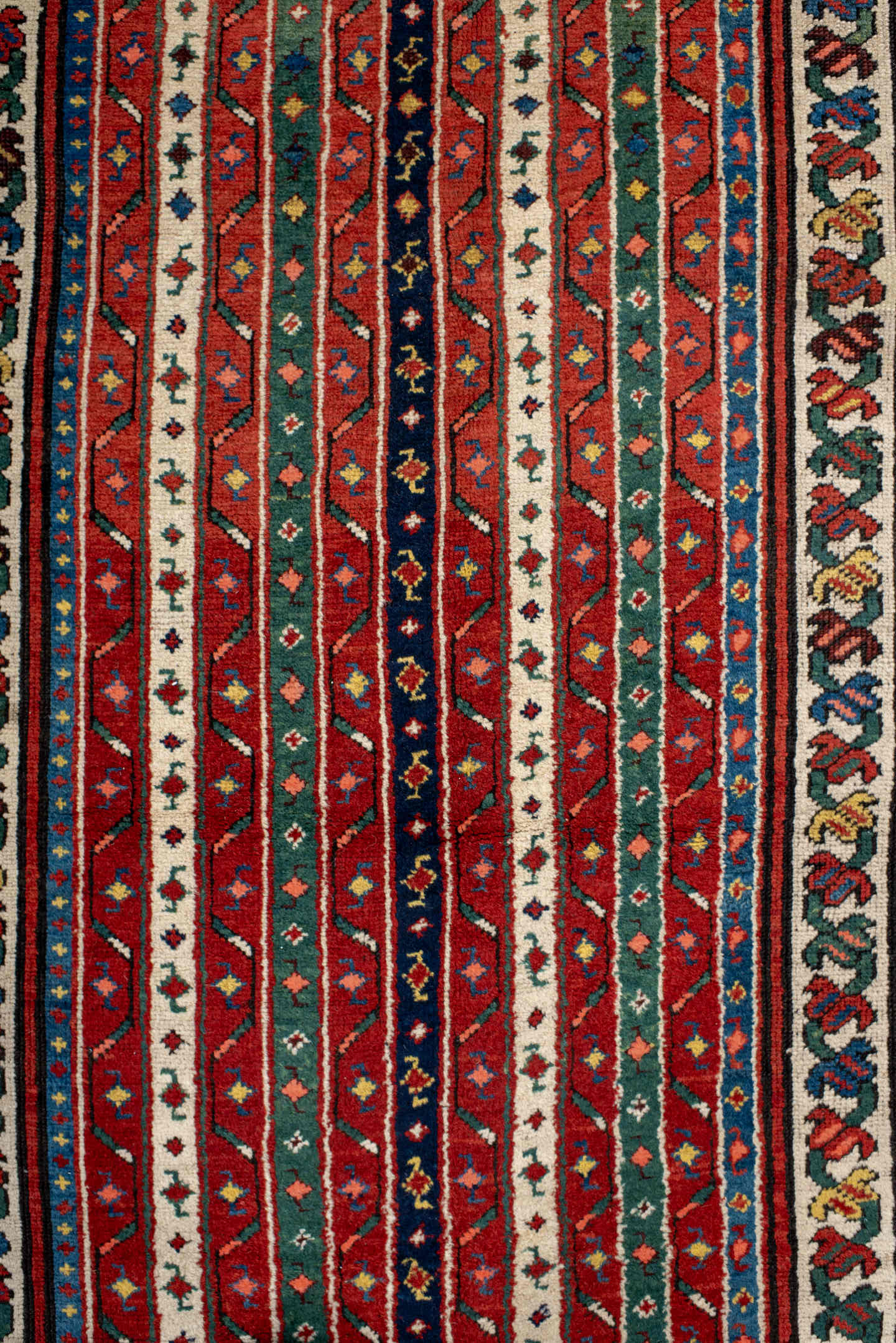 4' x 9' one-of-a-kind handmade antique Caucasian runner rug. Color palette: red, ivory, blue, teal, gold, navy, rust