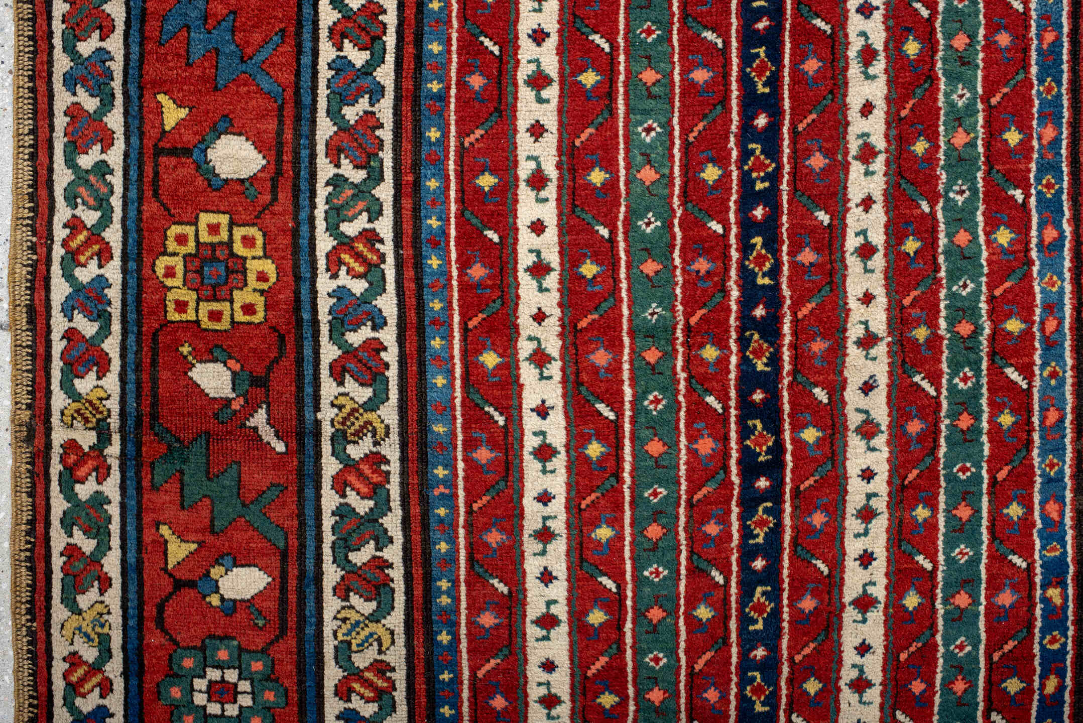 4' x 9' one-of-a-kind handmade antique Caucasian runner rug. Color palette: red, ivory, blue, teal, gold, navy, rust