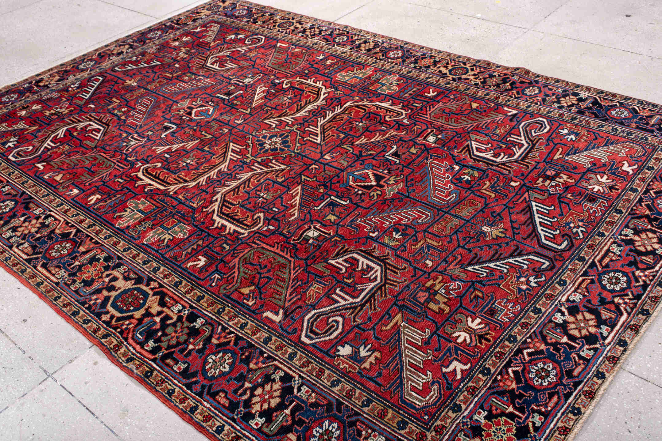 7' x 10' one-of-a-kind handmade antique Heriz large size rug. Color palette: red, navy, ivory, sky blue, camel, rust, brown