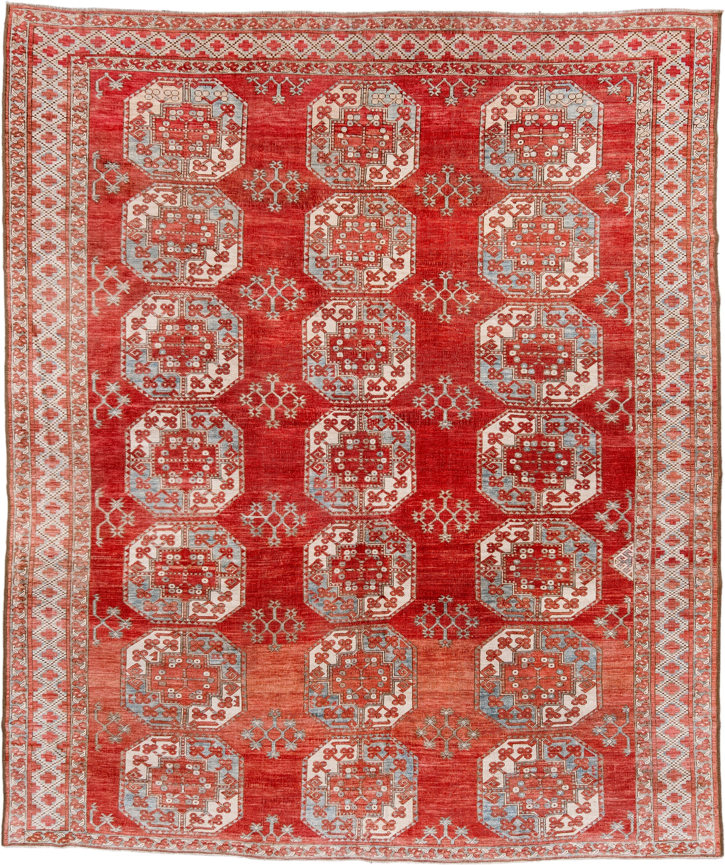 7' x 9' one-of-a-kind handmade antique Afghan rug. Color palette: red, ivory, rust, sky_blue, salmon, terracotta, brown