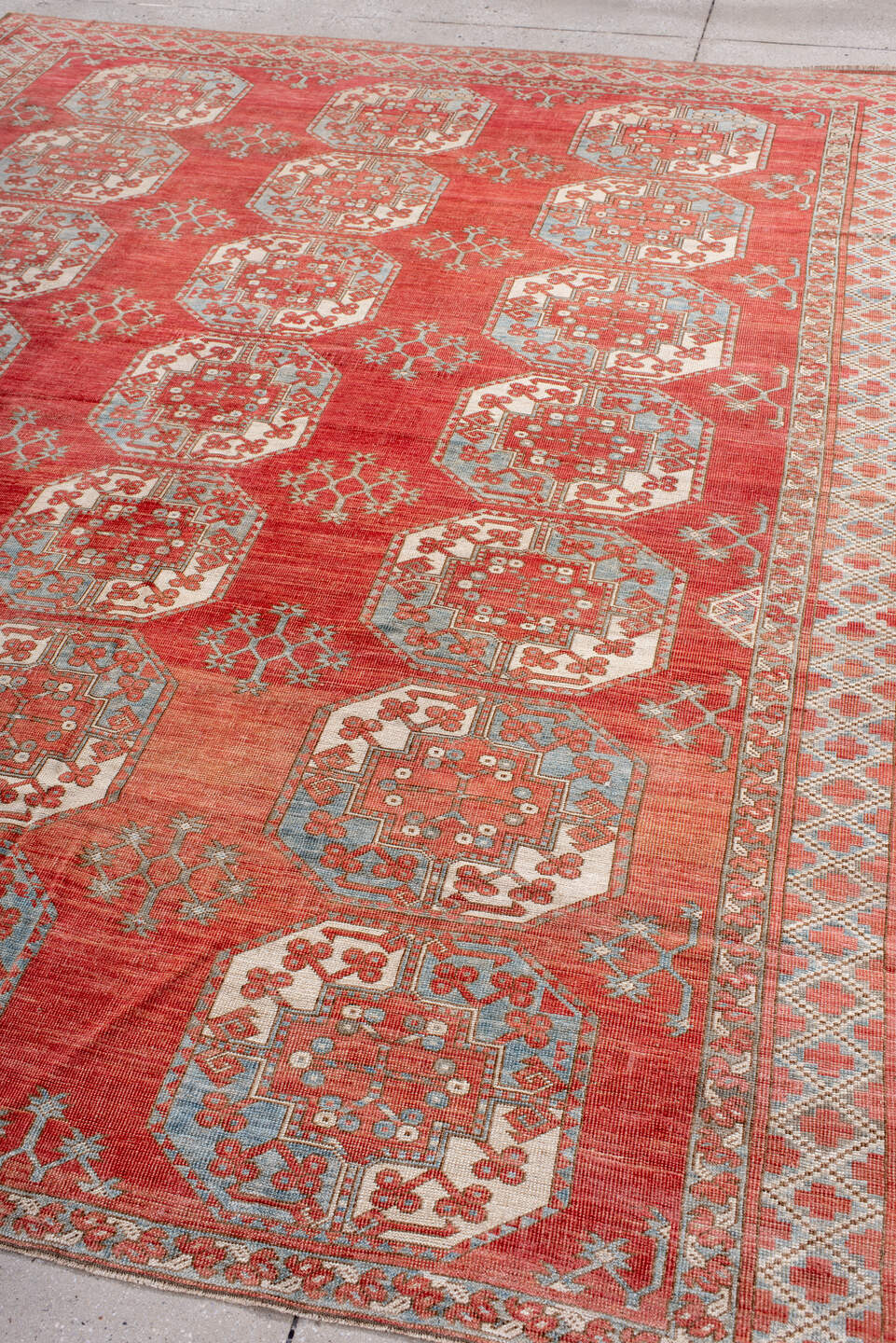 7' x 9' one-of-a-kind handmade antique Afghan rug. Color palette: red, ivory, rust, sky_blue, salmon, terracotta, brown