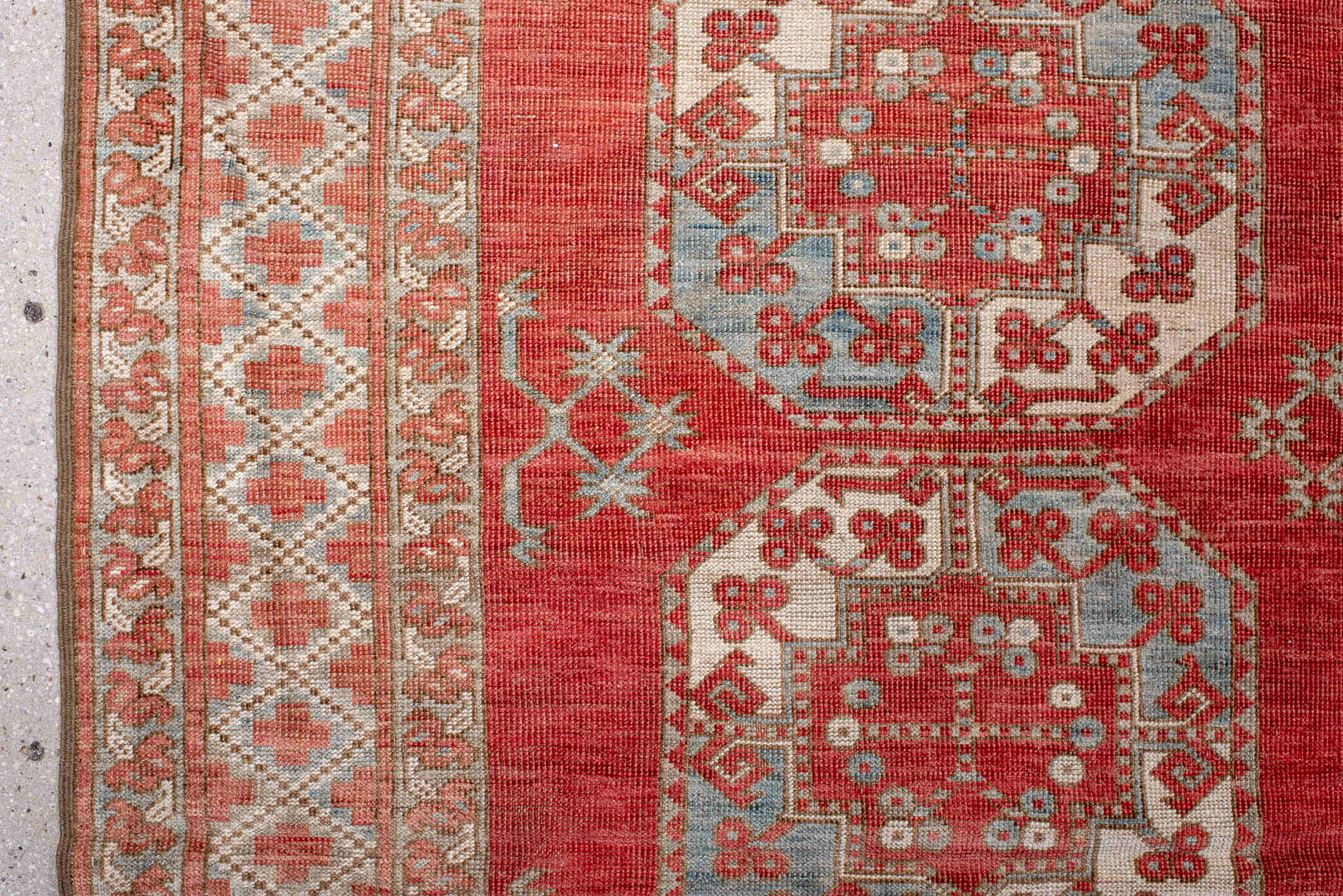 7' x 9' one-of-a-kind handmade antique Afghan rug. Color palette: red, ivory, rust, sky_blue, salmon, terracotta, brown
