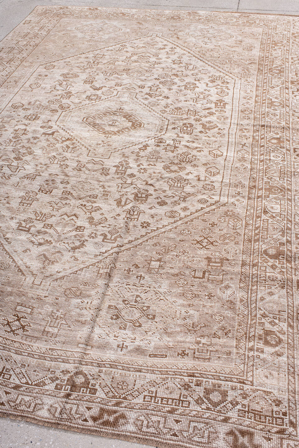 6' x 9' one-of-a-kind handmade antique Shiraz medium size rug. Color palette: ivory, taupe, camel, sand, light brown, beige