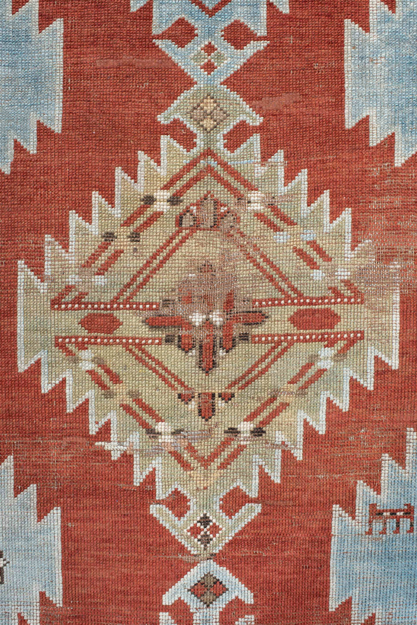 5' x 7' one-of-a-kind handmade antique Caucasian rug. Color palette: rust, sky blue, ivory, camel, taupe, crimson