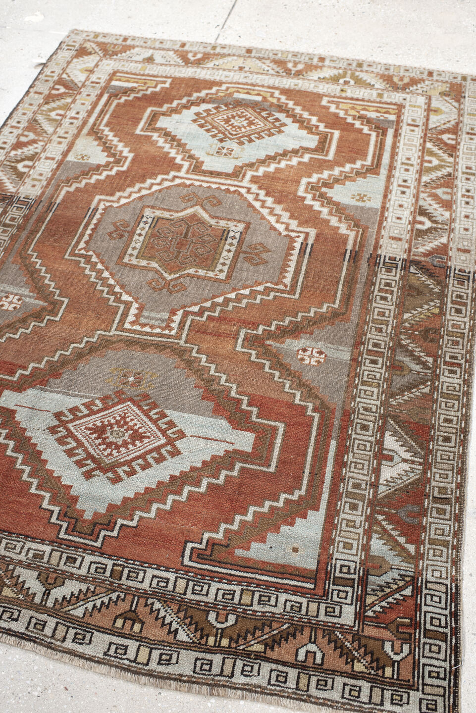 4' x 5' one-of-a-kind handmade vintage Caucasian small size rug. Color palette: brown, floral white, gray, light gray, linen