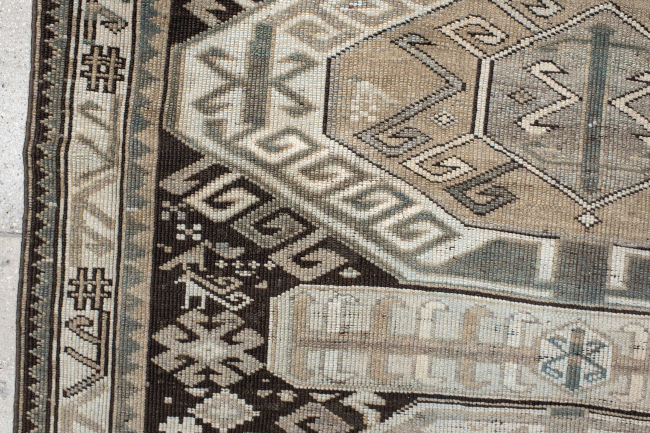 4' x 10' one-of-a-kind handmade antique Caucasian runner rug. Color palette: ivory, charcoal, taupe, brown, slate, gray