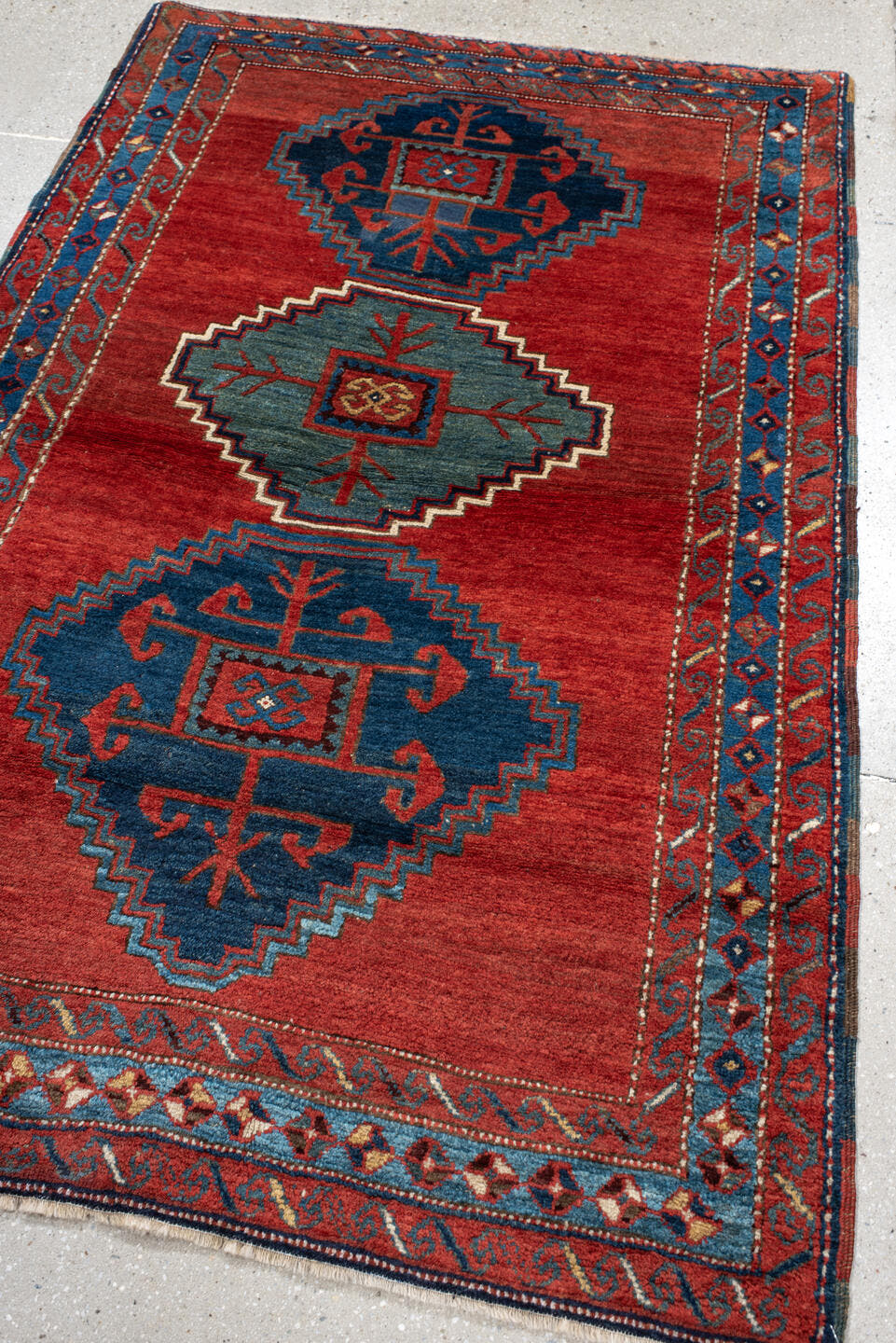 4' x 6' one-of-a-kind handmade antique Kazak small size rug. Color palette: rust, navy, sky_blue, ivory, brick, teal
