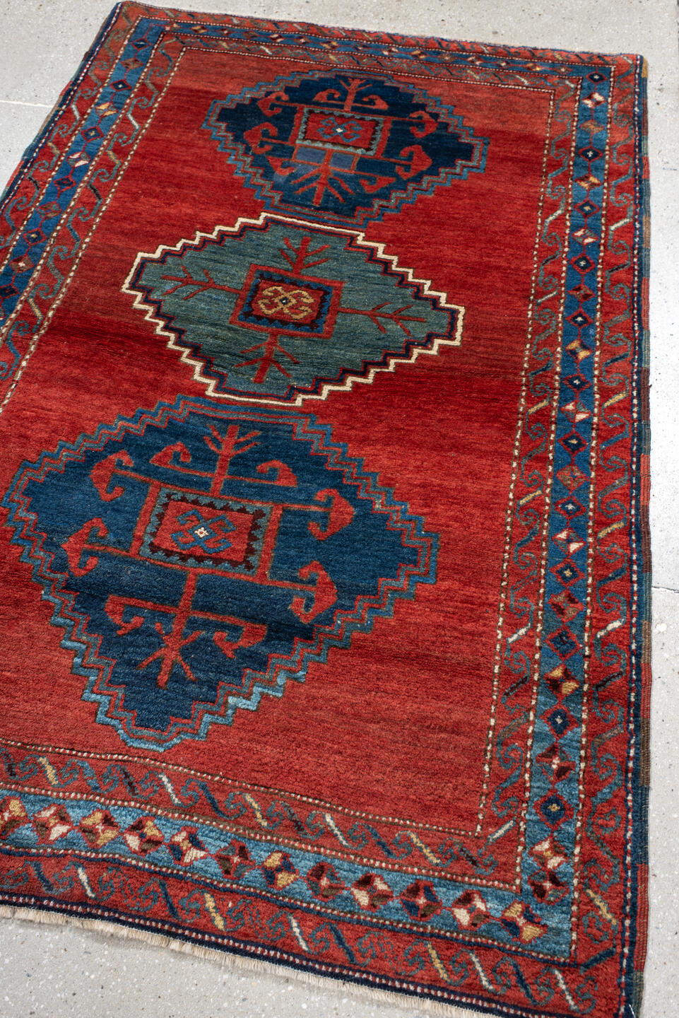 4' x 6' one-of-a-kind handmade antique Kazak small size rug. Color palette: rust, navy, sky_blue, ivory, brick, teal