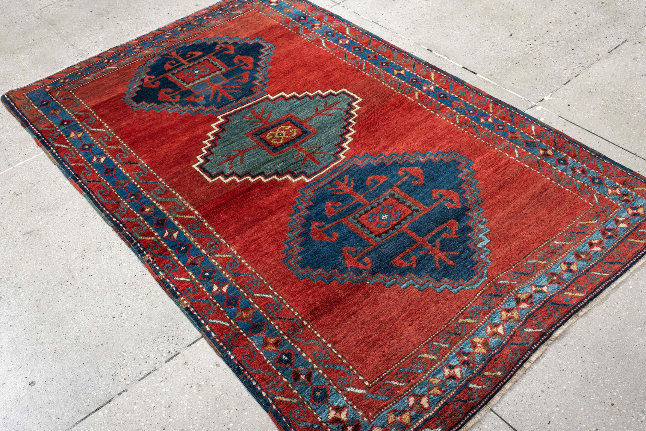 4' x 6' one-of-a-kind handmade antique Kazak small size rug. Color palette: rust, navy, sky_blue, ivory, brick, teal