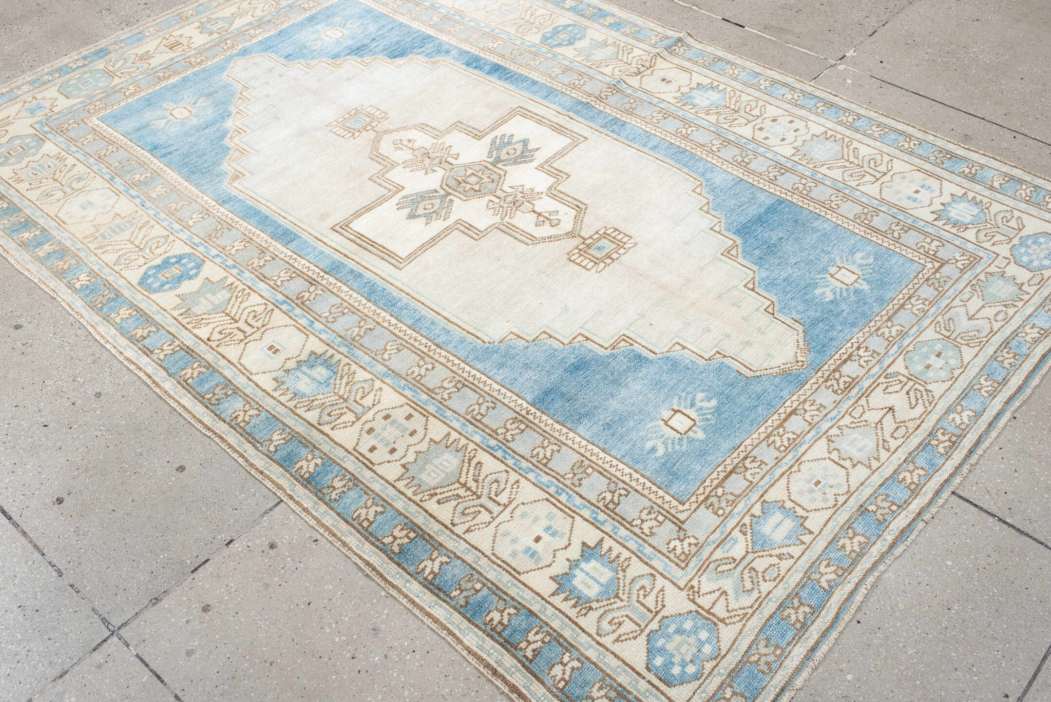 4' x 7' one-of-a-kind handmade vintage Anatolian rug. Color palette: ivory, sky blue, beige, taupe, camel, light blue, gray