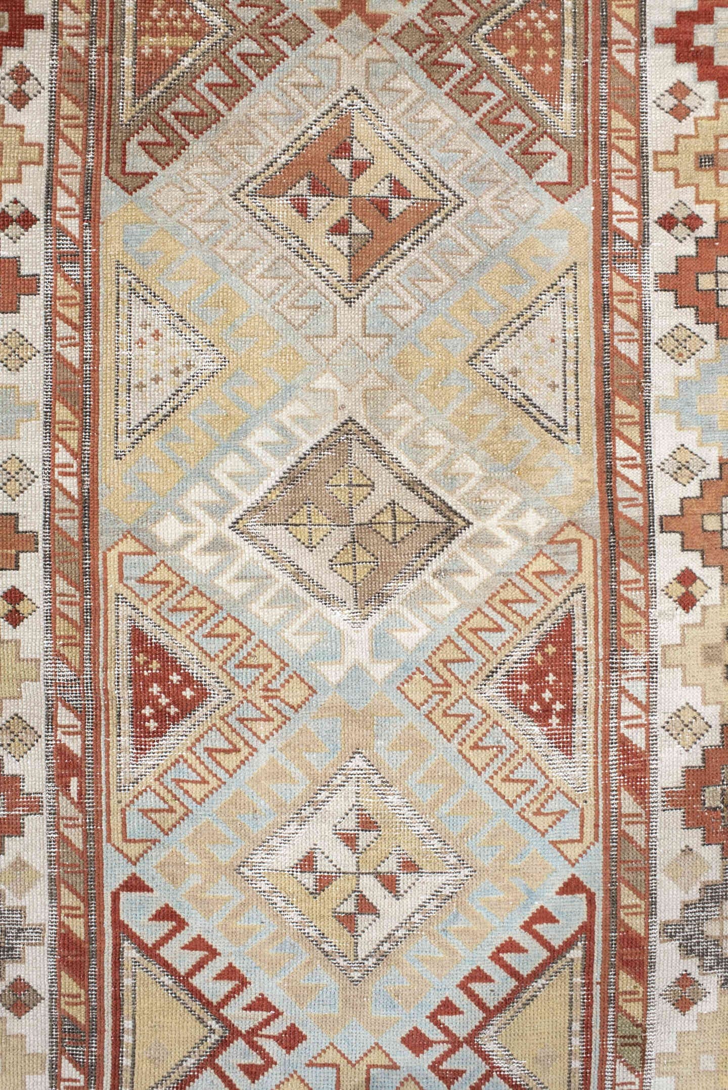 3' x 8' one-of-a-kind handmade antique Caucasian runner rug. Color palette: ivory, sky blue, rust, burgundy, camel, taupe