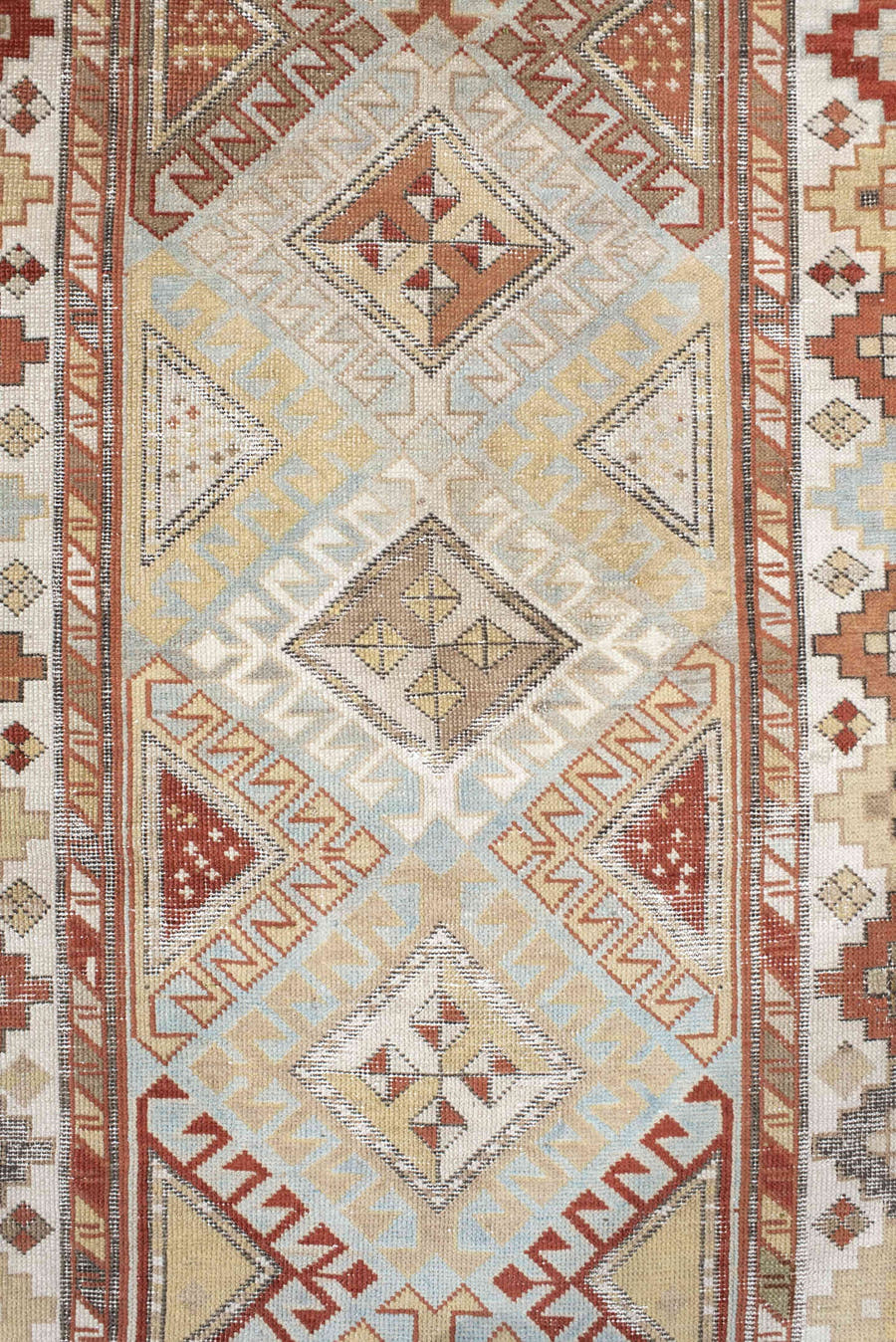 3' x 8' one-of-a-kind handmade antique Caucasian runner rug. Color palette: ivory, sky blue, rust, burgundy, camel, taupe
