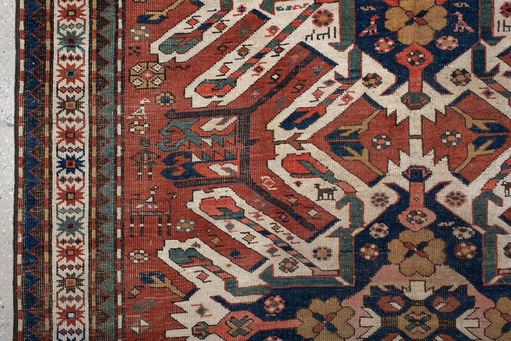 5' x 8' one-of-a-kind handmade antique Kazak medium size rug. Color palette: rust, ivory, navy, sage, gold, crimson, rose
