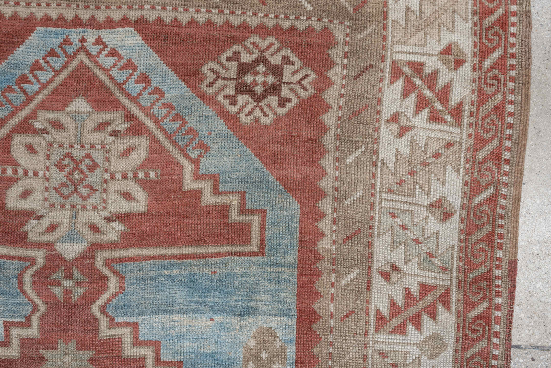 6' x 4' one-of-a-kind handmade antique Caucasian rug. Color palette: terracotta, ivory, sky blue, taupe, camel, brown