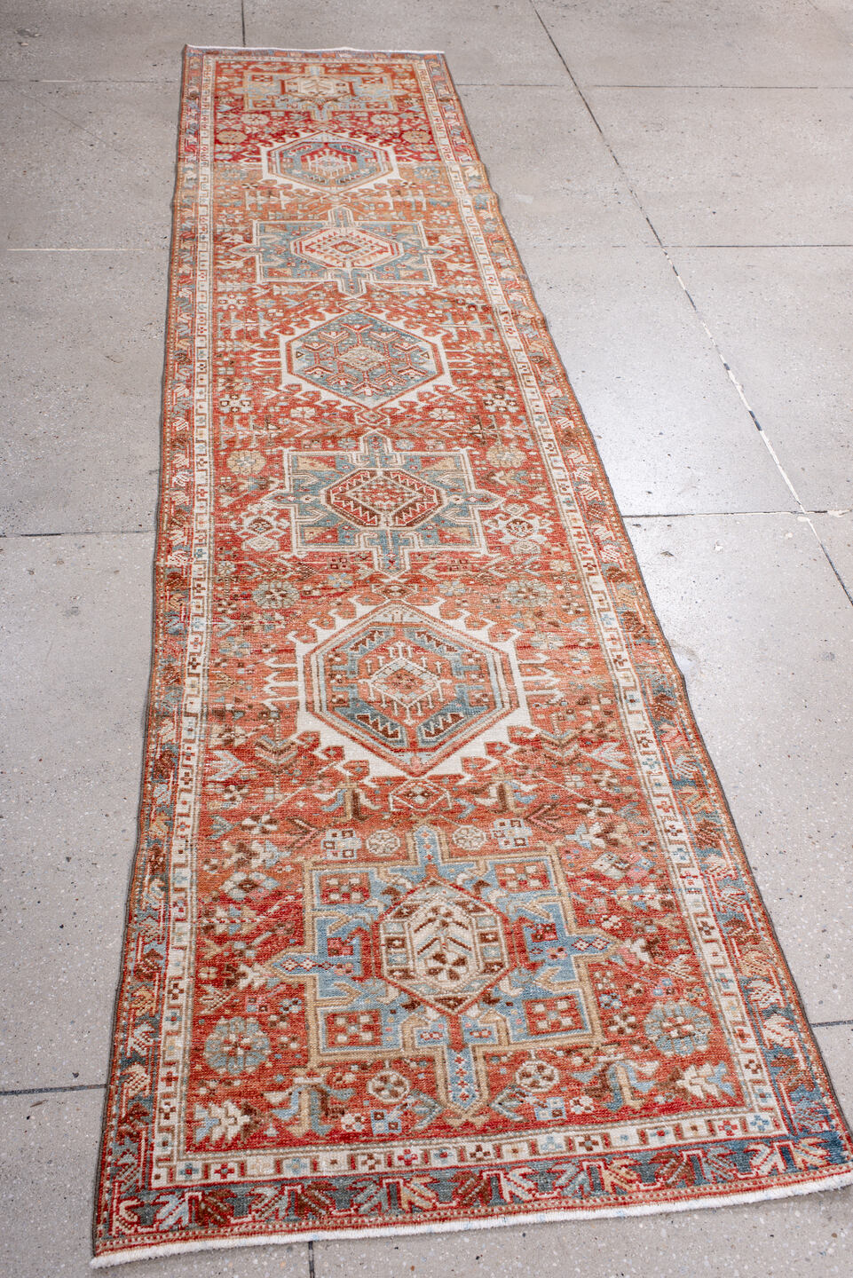 2' x 10' one-of-a-kind handmade antique Karaje runner rug. Color palette: rust, ivory, sky_blue, terra_cotta, camel, slate