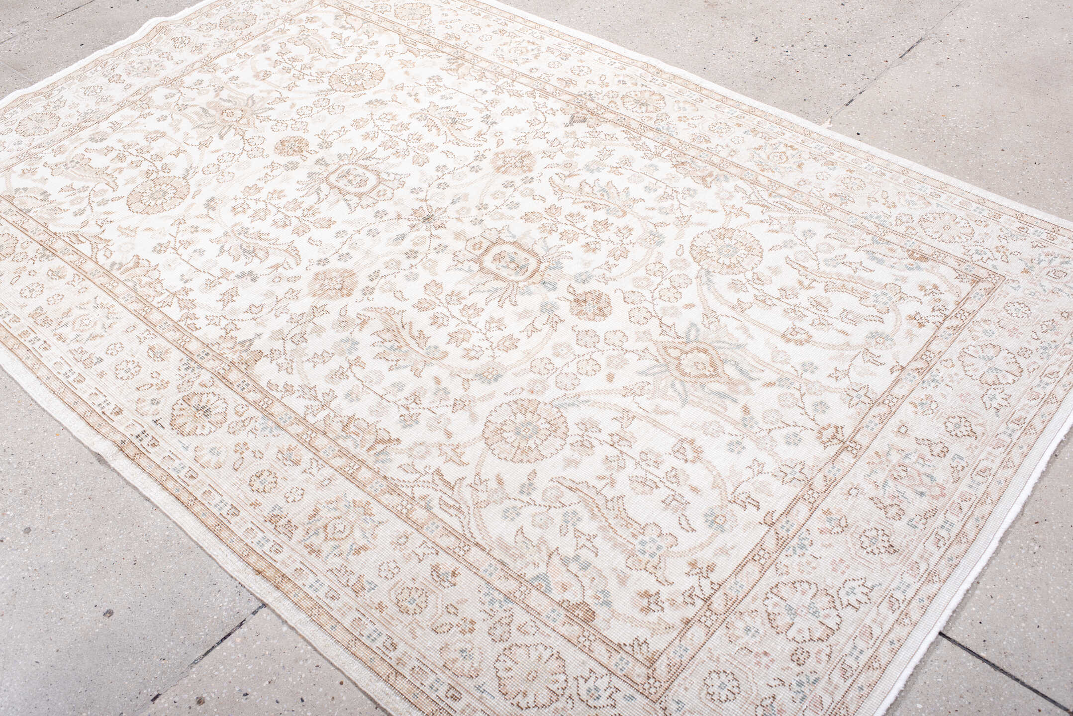 5' x 7' one-of-a-kind handmade antique Sparta rug. Color palette: ivory, beige, taupe, camel, pale blue, sand, gray