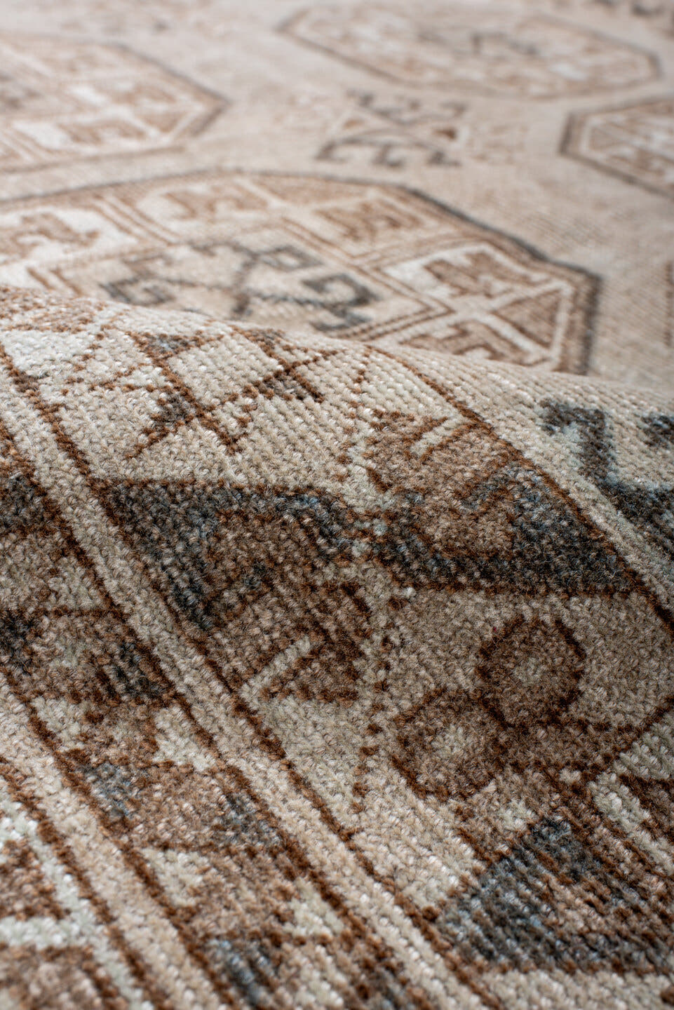 5' x 7' one-of-a-kind handmade antique Afghan rug. Color palette: ivory, taupe, camel, brown, charcoal, beige, gray, black