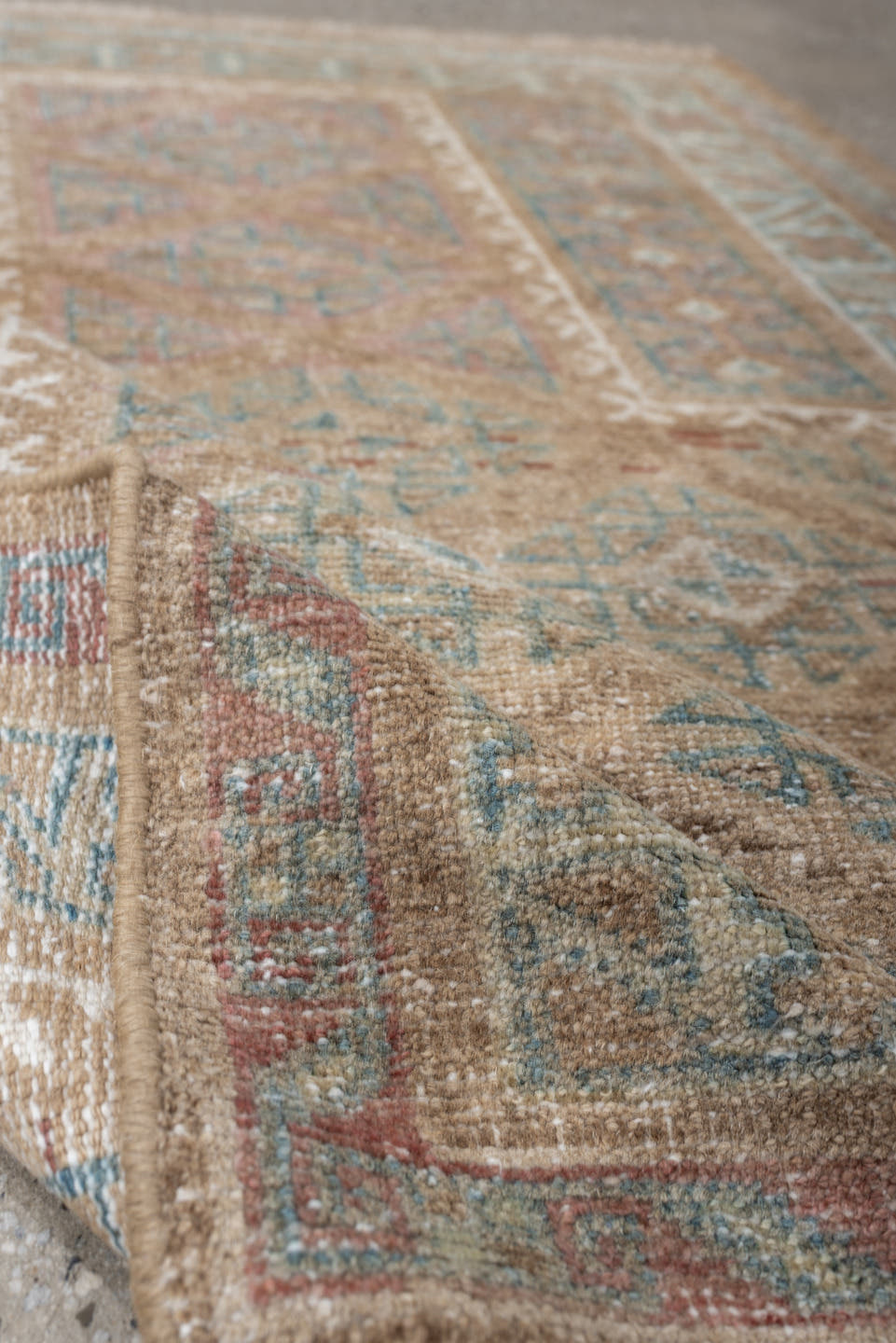 2' x 4' one-of-a-kind handmade antique Belouch small size rug. Color palette: camel, ivory, faded teal, taupe, muted rust