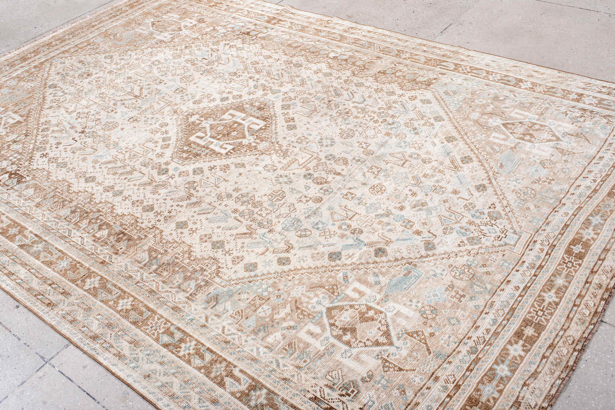 6' x 10' one-of-a-kind handmade antique Shiraz large size rug. Color palette: ivory, camel, taupe, pale blue, cream, sand