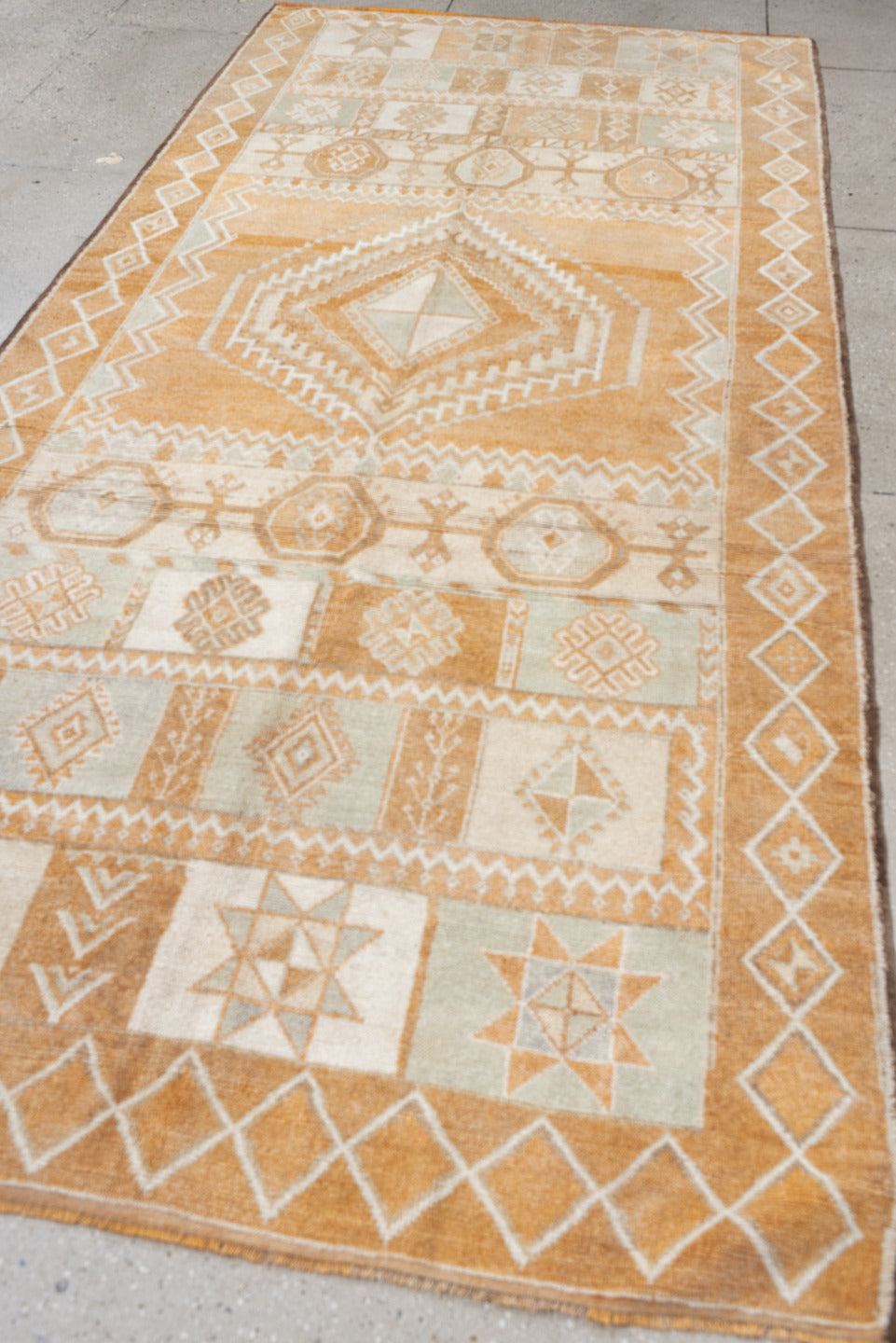 5' x 11' one-of-a-kind handmade antique Moroccan rug. Color palette: apricot, ivory, pale blue, sand, cream, terracotta