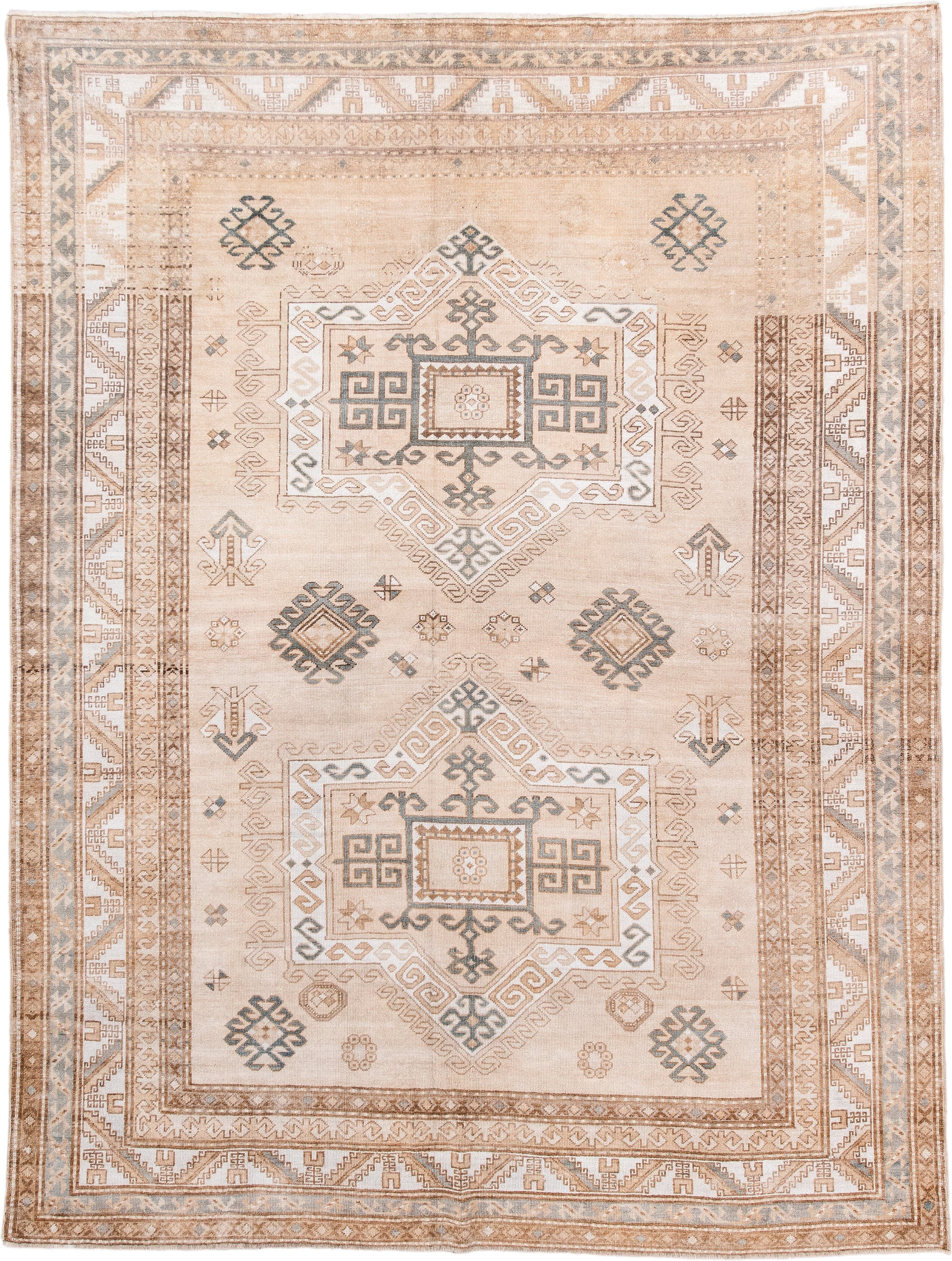 7' x 9' one-of-a-kind handmade antique Trans Caucasian rug. Color palette: ivory, camel, taupe, slate, sand, pewter, beige