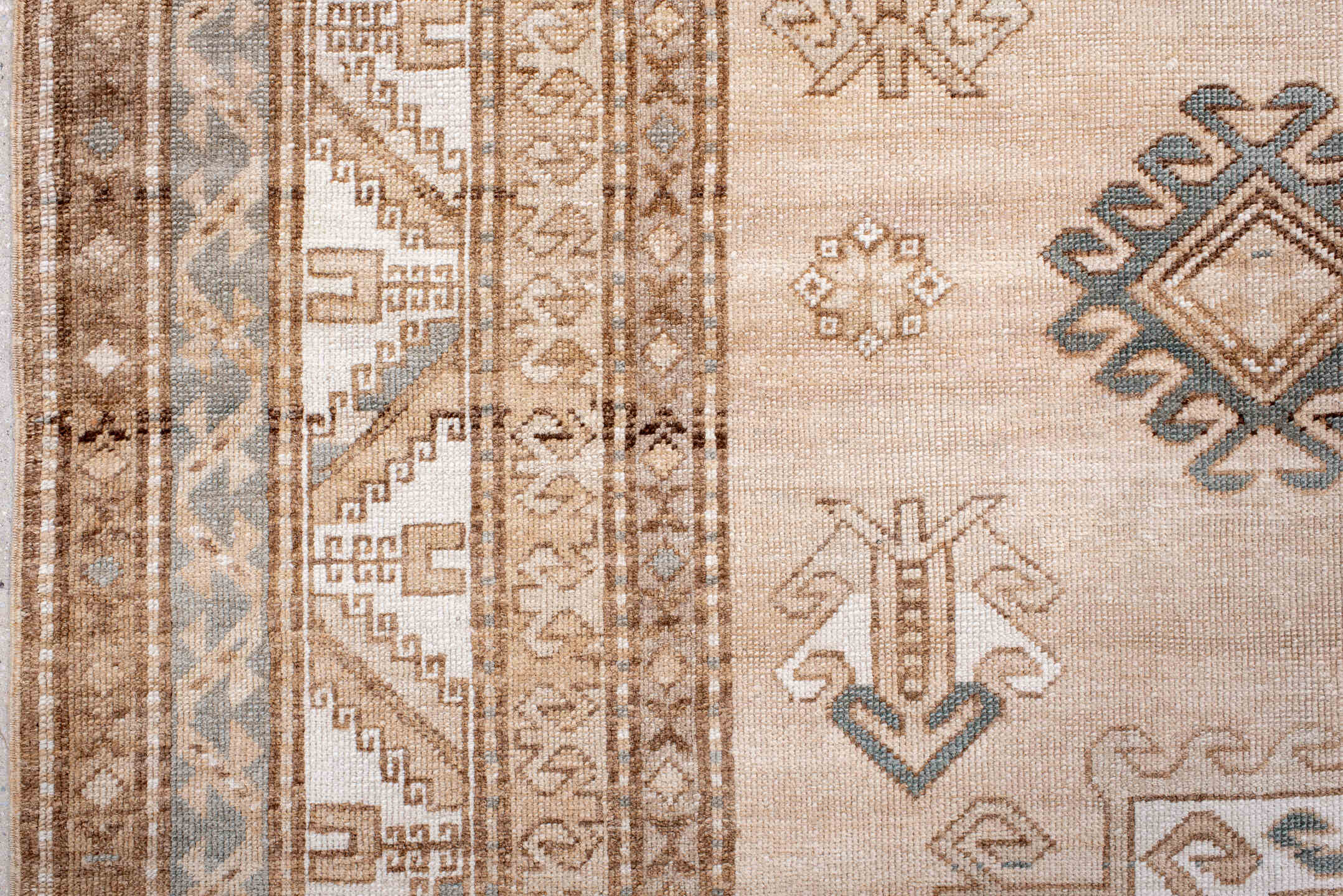 7' x 9' one-of-a-kind handmade antique Trans Caucasian rug. Color palette: ivory, camel, taupe, slate, sand, pewter, beige