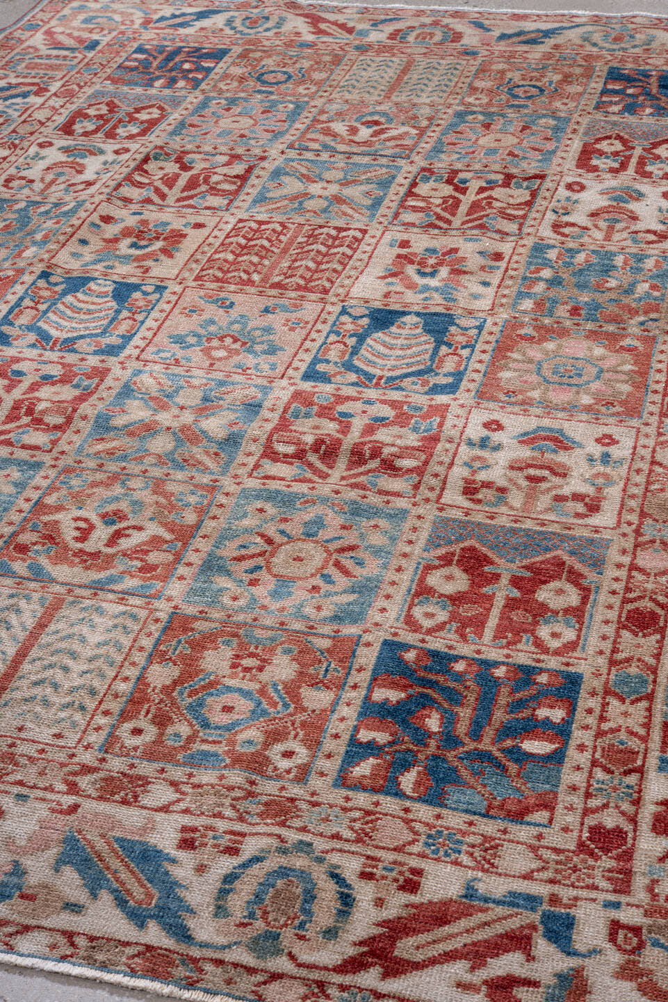 7' x 9' one-of-a-kind handmade vintage Baktiary rug. Color palette: ivory, coral, brick red, sky blue, dusty rose
