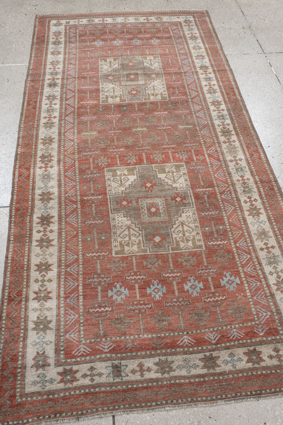 3' x 7' one-of-a-kind handmade antique Belouch runner rug. Color palette: terra cotta, ivory, taupe, brown, slate, rust
