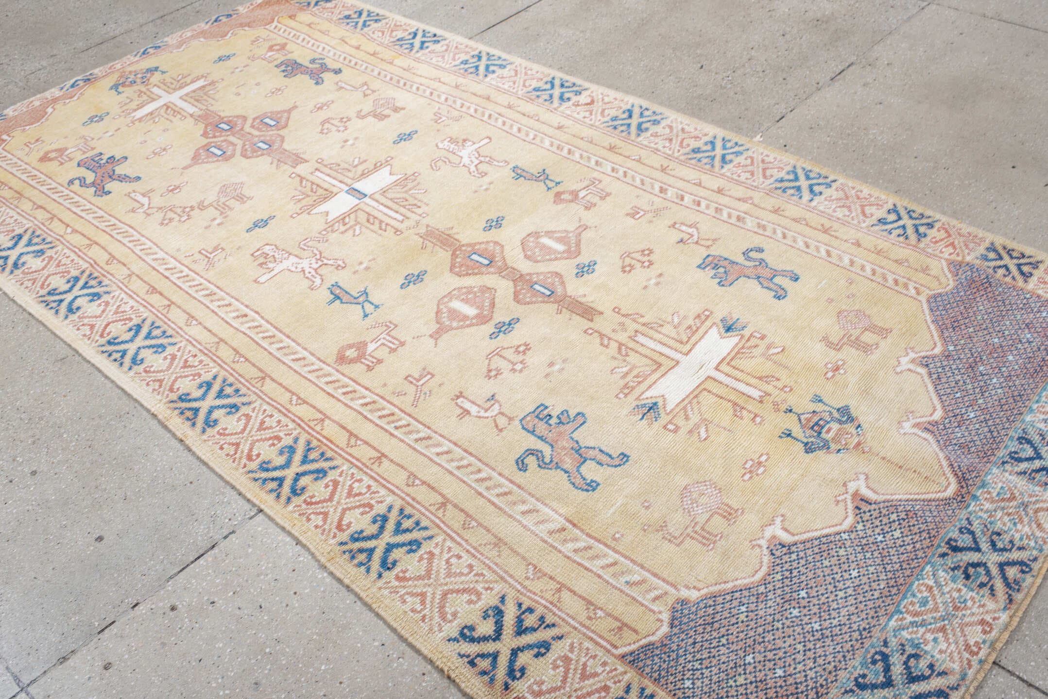 4' x 9' one-of-a-kind handmade antique Moroccan rug. Color palette: ivory, rose, blue, navy, cream, taupe, pink, red, beige