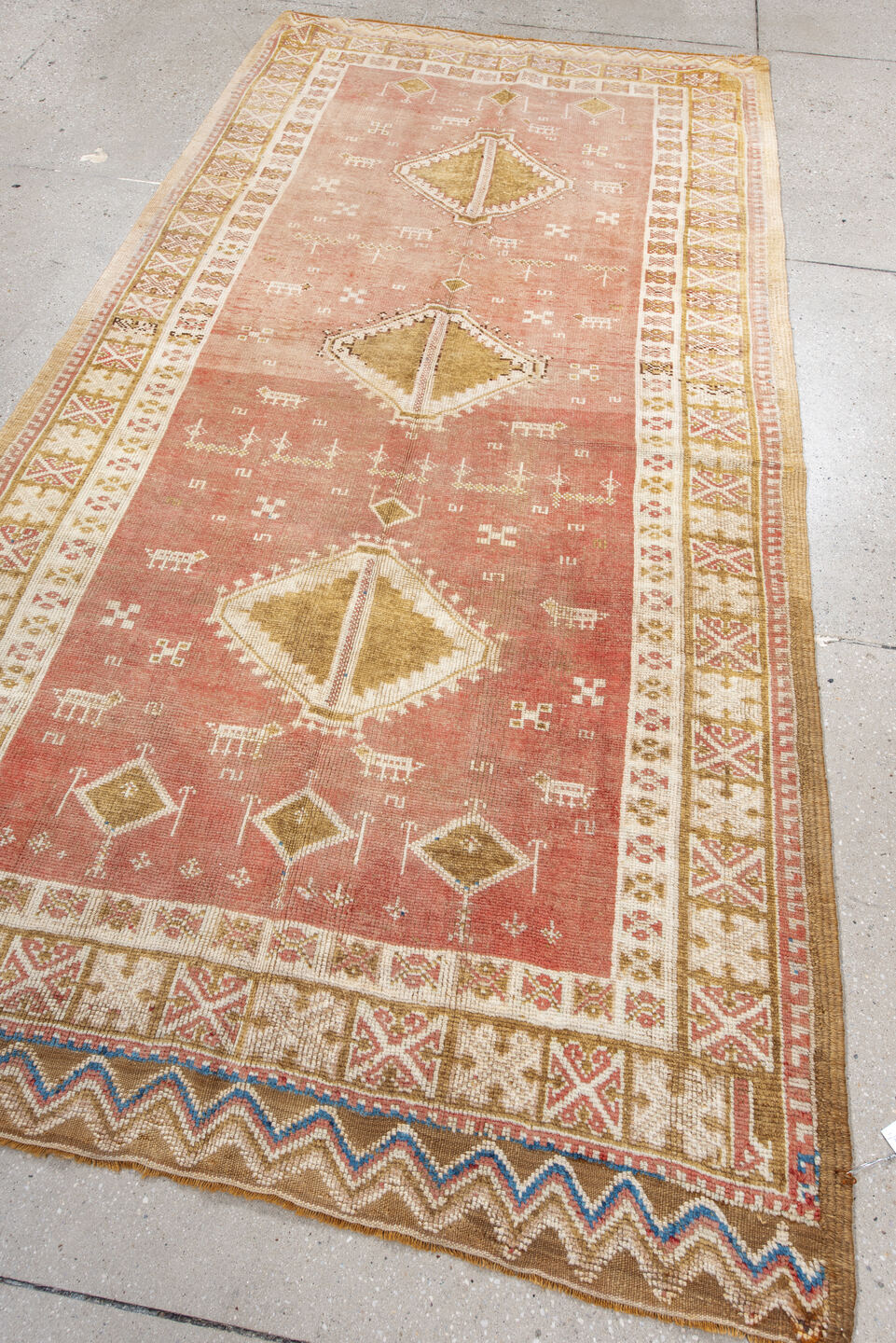 4' x 8' one-of-a-kind handmade antique Moroccan rug. Color palette: salmon, ivory, ochre, camel, rose, tan, blue, pink, gold
