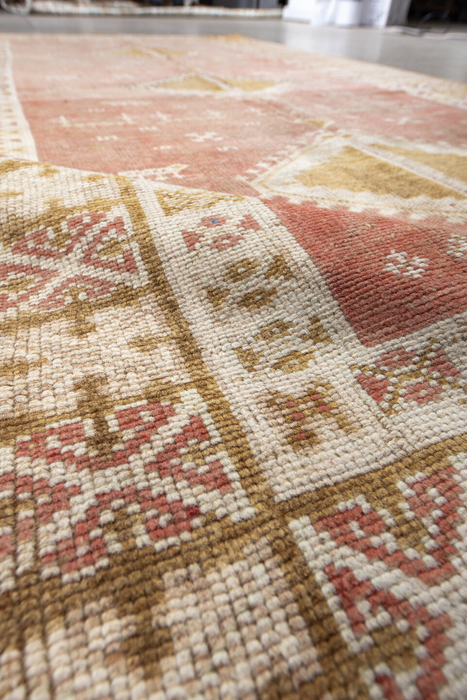 4' x 8' one-of-a-kind handmade antique Moroccan rug. Color palette: salmon, ivory, ochre, camel, rose, tan, blue, pink, gold